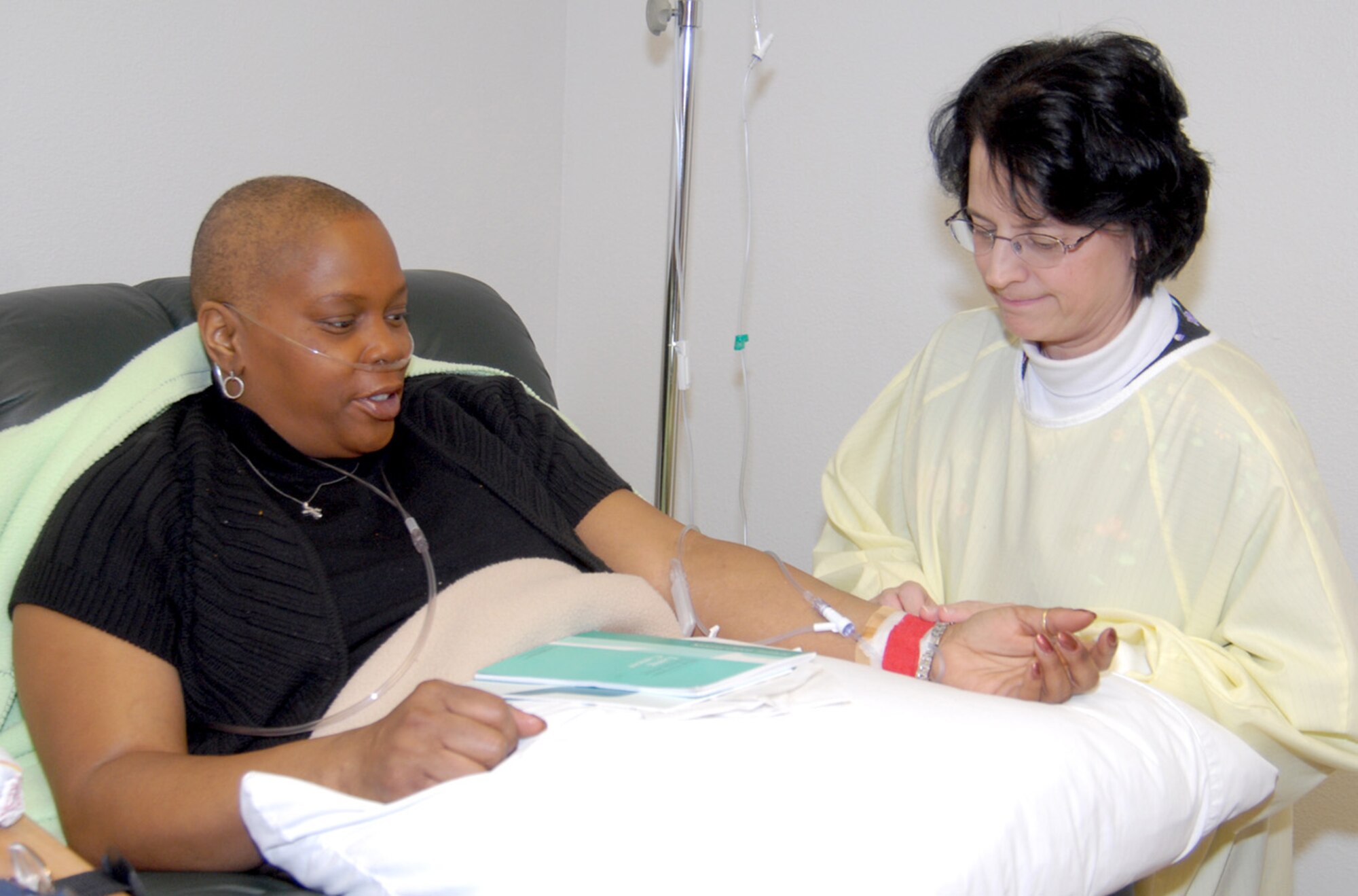 Carol Tafoya, a nurse at the hospital Mrs. Gavins entered, inserts the IV into the patient’s arm.
