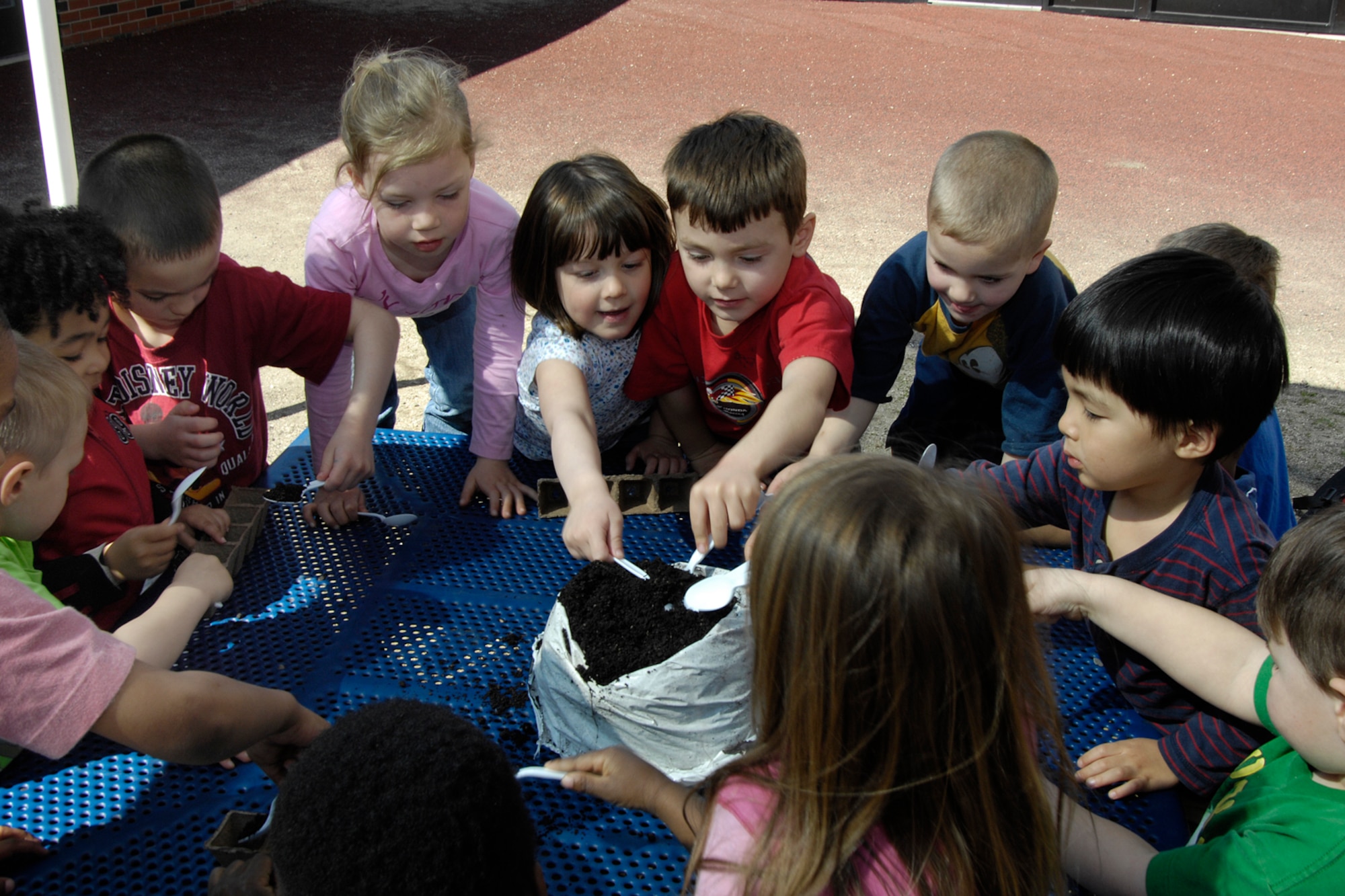 HANSCOM AFB, Mass. – Children in Room 5 at the Child Development Center work together to plant some seeds for their garden on April 17. The activity was part of the Center’s month-long celebrations to honor military children. (U.S. Air Force photo by Linda LaBonte Britt)