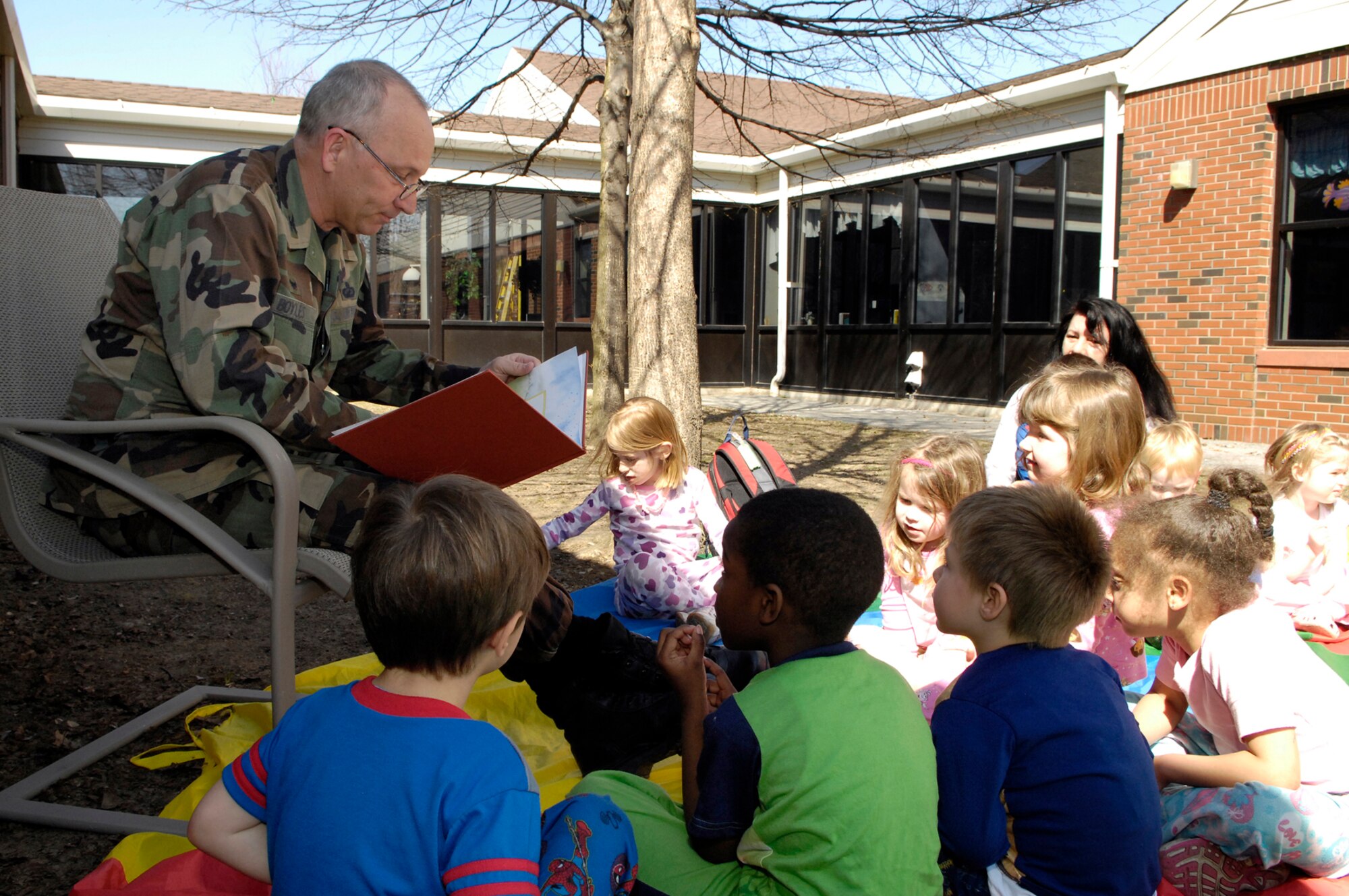 HANSCOM AFB, Mass. – Col. Robert Boyles (left), 66th Mission Support Group commander reads a book to children in Classroom 8 at the Child Development Center on April 18. The activity was one of many that are scheduled as part of Hanscom’s Month of the Military Child celebrations. (U.S. Air Force photo by Mark Wyatt)

