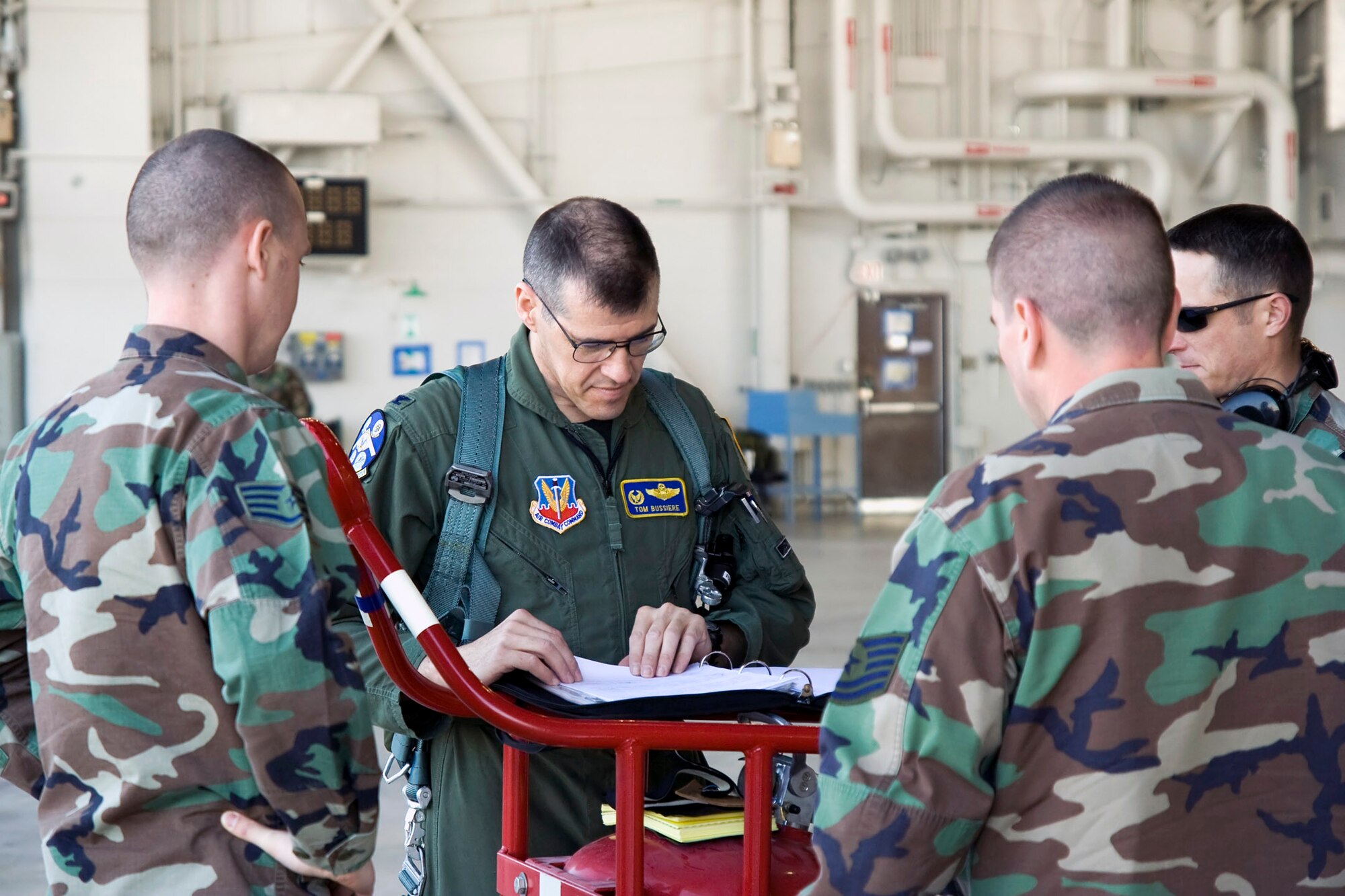 Col. Tom Bussiere reviews aircraft forms with maintainers prior to flying a B-2 Spirit named the Spirit of Florida April 15 at Whiteman Air Force Base, Mo. The flight was the first since a B-2 crashed Feb. 23 at Andersen AFB, Guam. Colonel Bussiere is the 509th Operations Group commander. (U.S. Air Force photo/Capt. Allen Clark) 
