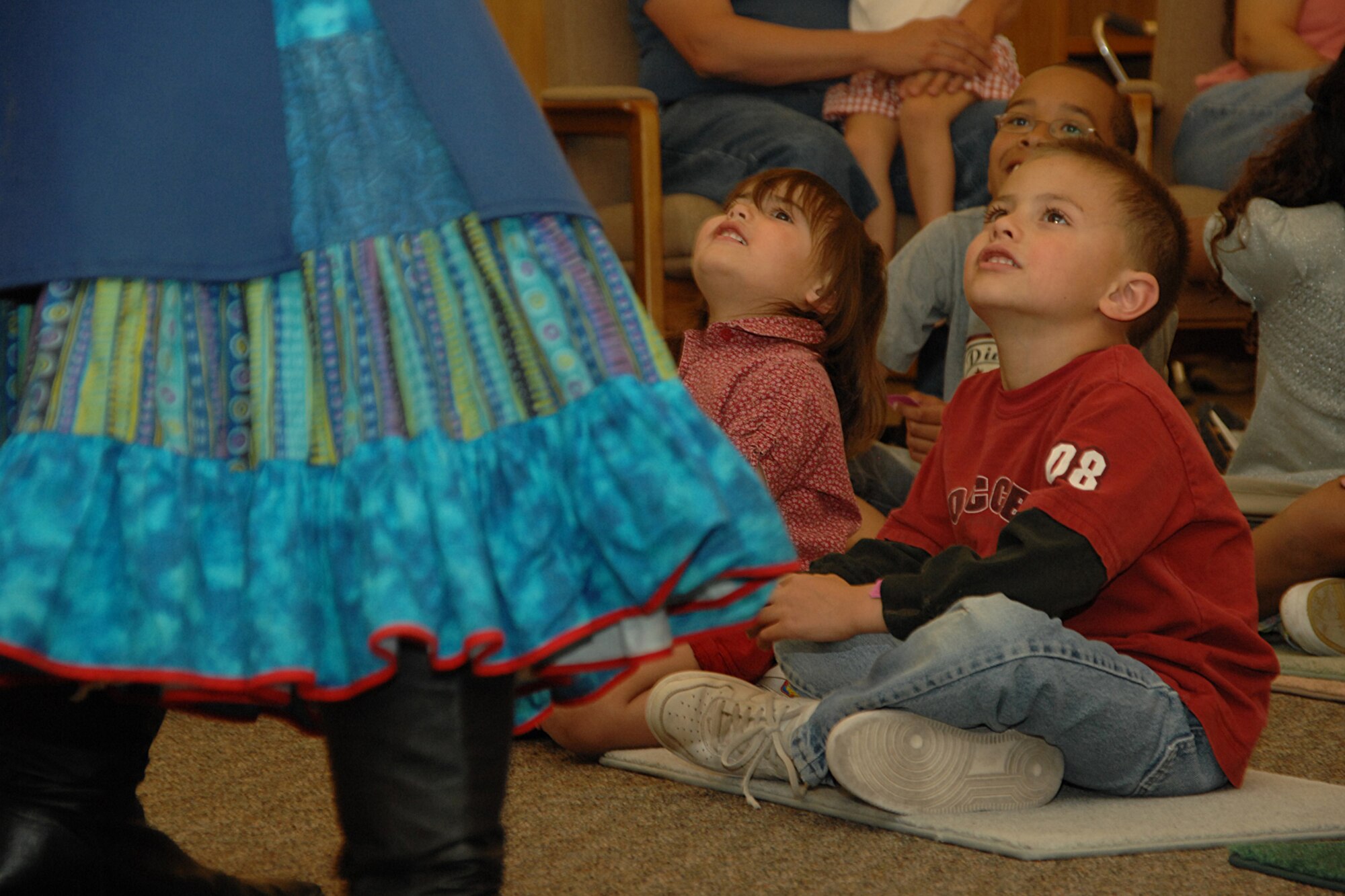 HOLLOMAN AIR FORCE BASE, N.M. -- Chase Faulkenberry, 8, and Autumn Faulkenberry, 3, watch as Terry Alvarez, story dancer, performs here April 16 at the base library. Alvarez performed for parents and children as part of National Library Week, which was first sponsored in 1958. (U.S. Air Force photo/ Airman 1st Class Jamal D. Sutter)