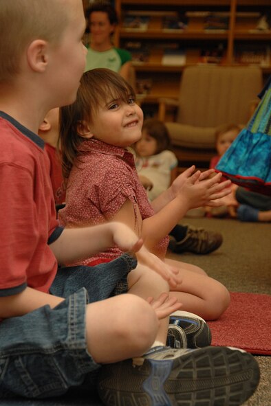 HOLLOMAN AIR FORCE BASE, N.M. -- Autumn Faulkenberry, 3, applauses after a performance by Terry Alvarez April 16 at the base library here. Parents and children came out in support of National Library Week. (U.S. Air Force photo/ Airman 1st Class Jamal D. Sutter)