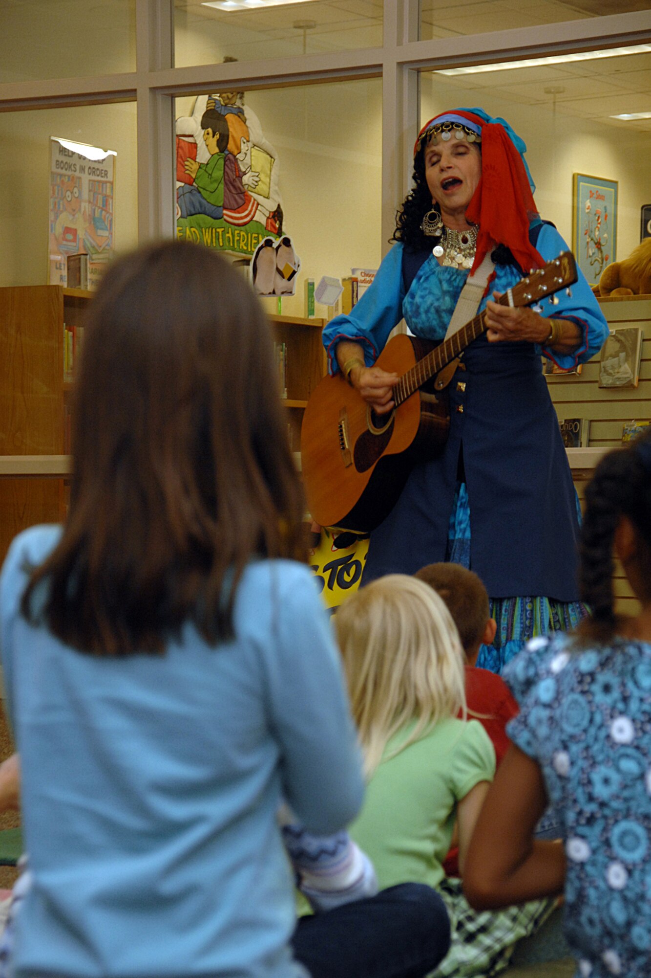 HOLLOMAN AIR FORCE BASE, N.M. -- Terry Alvarez, story dancer, performs the Purple Bean April 16 at the base library here. In her performance, Alvarez used a guitar, drum set, puppets, costumes and presentations. (U.S. Air Force photo/ Airman 1st Class Jamal D. Sutter)
