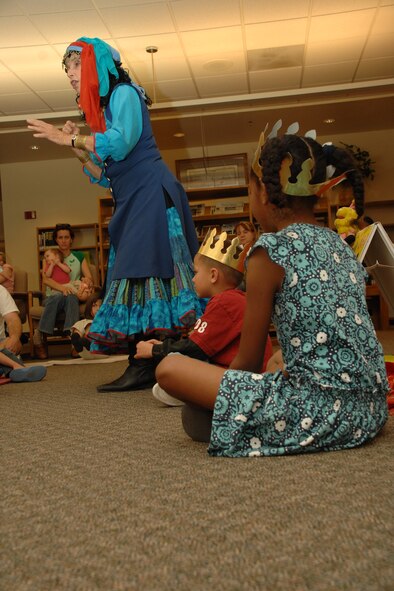 HOLLOMAN AIR FORCE BASE, N.M. -- Assisted by Claudia Rodriguez, 8, and Chase Faulkenberry, 5, Terry Alvarez, story dancer, tells the folktale of the Purple Bean April 16 at the base library here. Chase and Claudia played a role in the story as the king and queen of the rabbits. (U.S. Air Force photo/ Airman 1st Class Jamal D. Sutter)