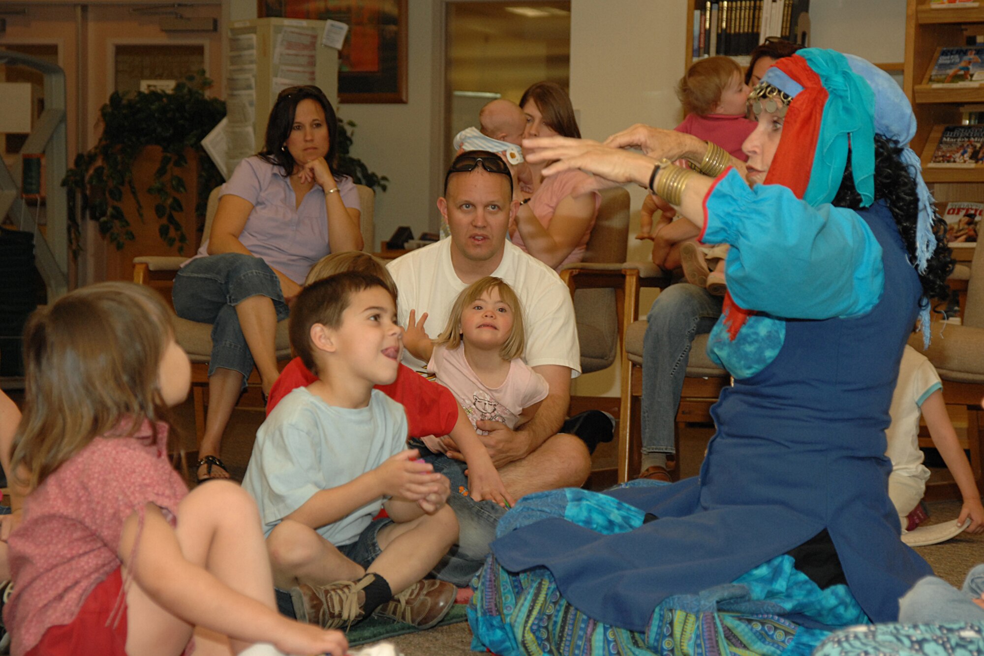 HOLLOMAN AIR FORCE BASE, N.M. -- Terry Alvarez, story dancer, tells a folktale to children April 16 at the base library here. After Alvarez’s performance, the library staff held drawings for door prizes. There were also refreshments available for parents and children. (U.S. Air Force photo/ Airman 1st Class Jamal D. Sutter)