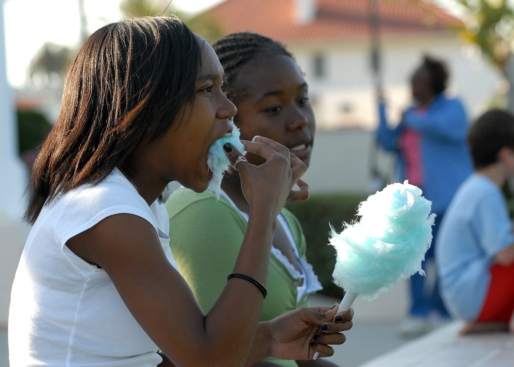 Two family members enjoy cotton candy at the Military Child Fun Fest, April 11.  Approximately 300 people attended the event at the Fort MacArthur Community Center.  Besides food and games, the base’s Helping Agencies set up booths to provide information for families. (Photo by Stephen Schester)