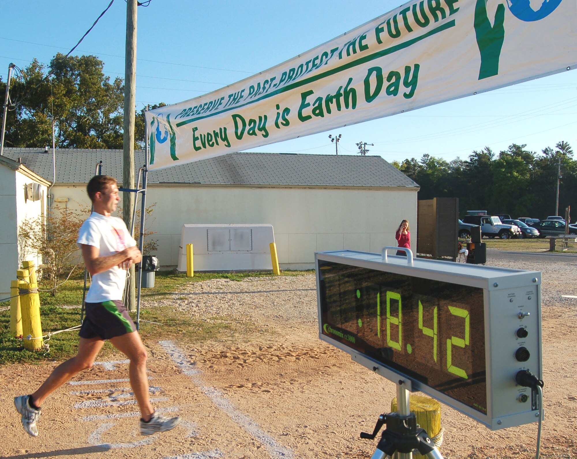 EGLIN AIR FORCE BASE, Fla. -- Capt. Andrew Norton, Air Armament Center assistant staff judge advocate, passes the finish line during the Earth Day 5k Fun Run/Walk event at Foster Stadium April 17.  Captain Norton was the first man to pass the finish line, winning a $25 Army and Air Force Exchange Service gift certificate.  Capt. Scott Griffith, 36th Electronic Warfare Squadron (18:50/$15 AAFES gift certificate) and Robert Crist, 846th Test Support Squadron (19:56/$10 AAFES gift certificate) came in second and third places, respectively. (U.S. Air Force photo by Jerron Barnett)