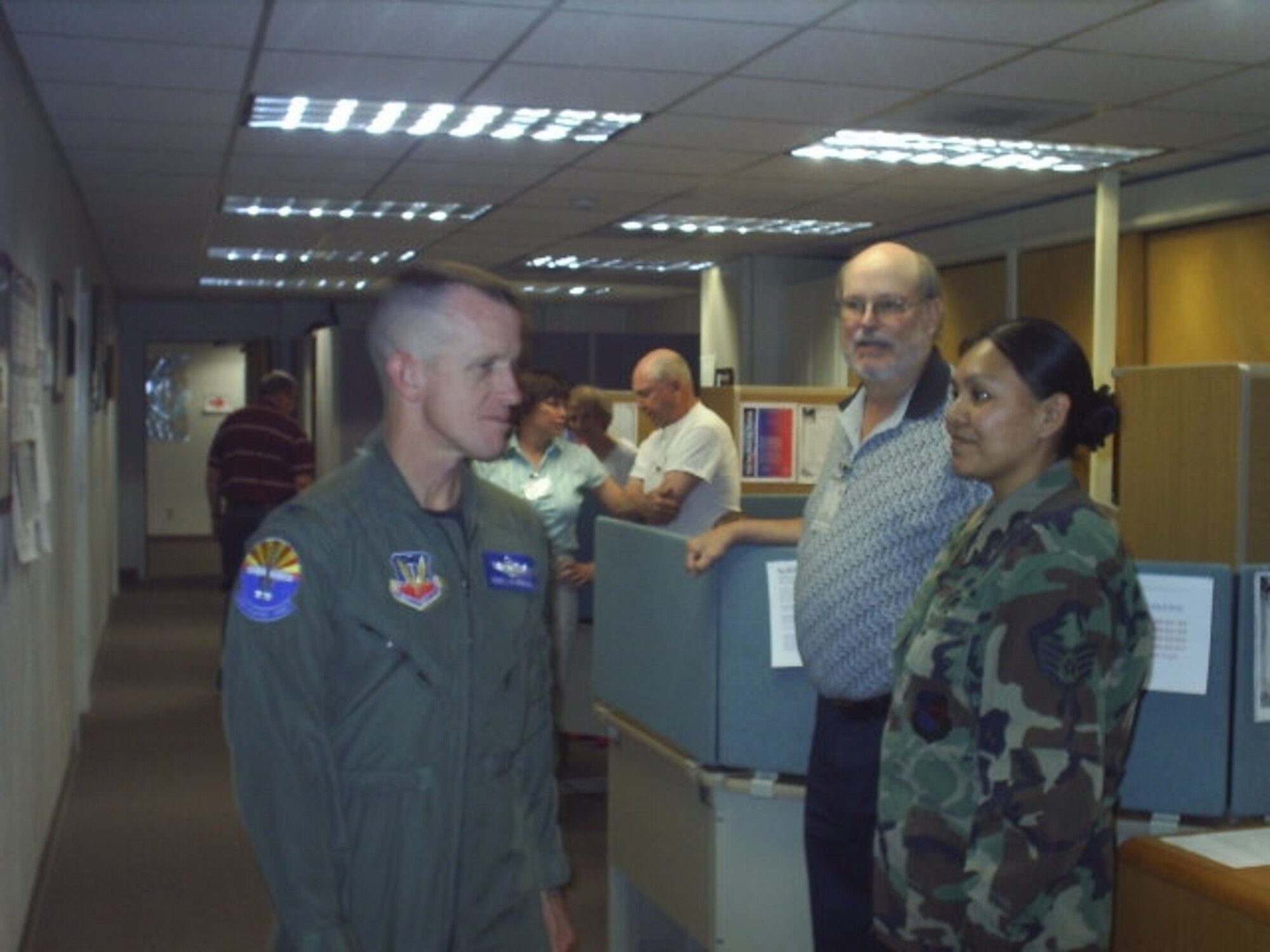 Col. Kent Laughbaum, 355th Fighter Wing commander, congratulates Staff Sgt. Joy Hollonquest, VITA NCOIC, and Skip Barkley, VITA site coordinator, on a successful tax season. (Courtesy photo)
