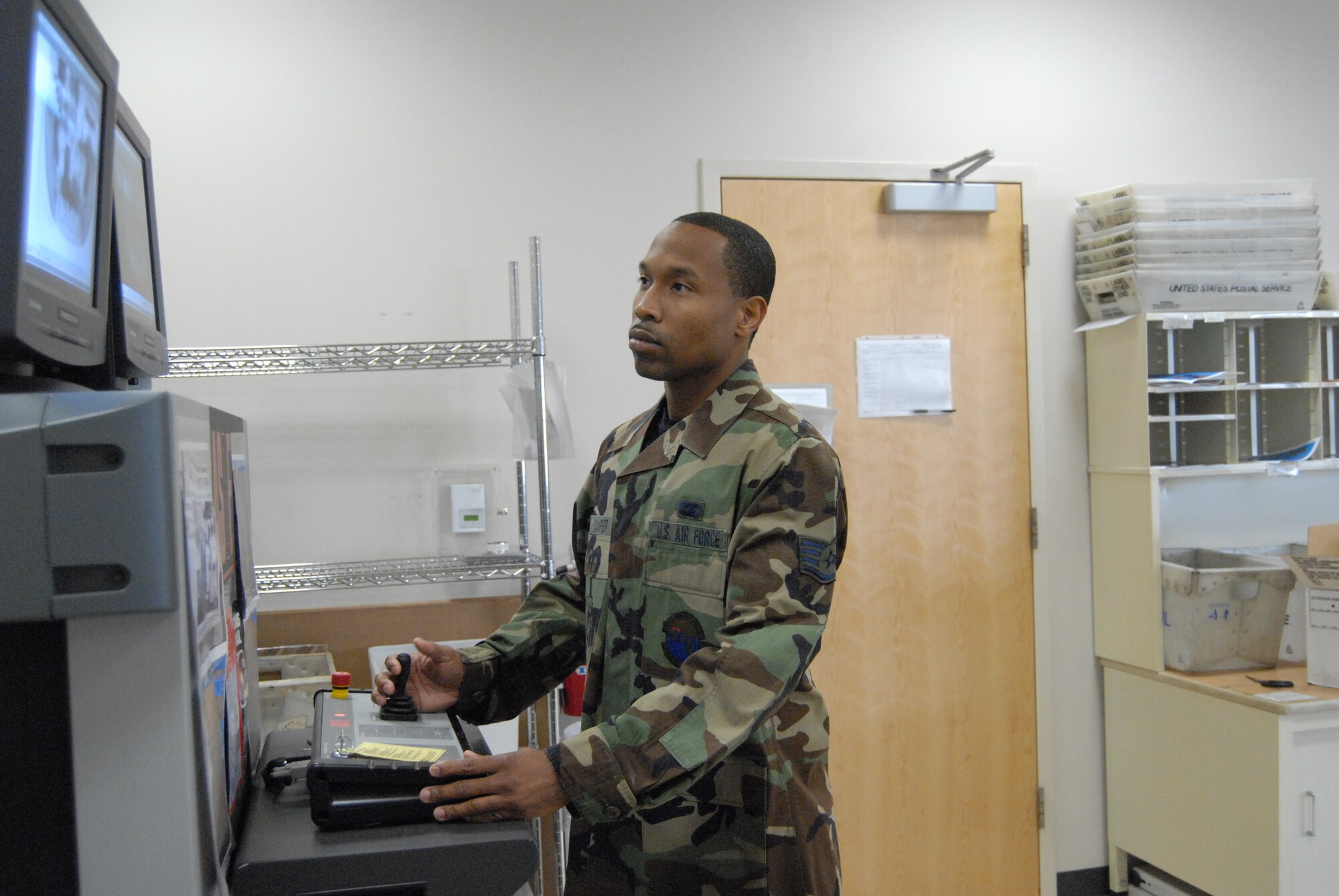 Staff Sgt. Jamell Camper, 43rd Communications Squadron, scans a package received through Fort Bragg's delivery system Monday at the post office. (U.S. Air Force Photo by Airman 1st Class Mindy Bloem)