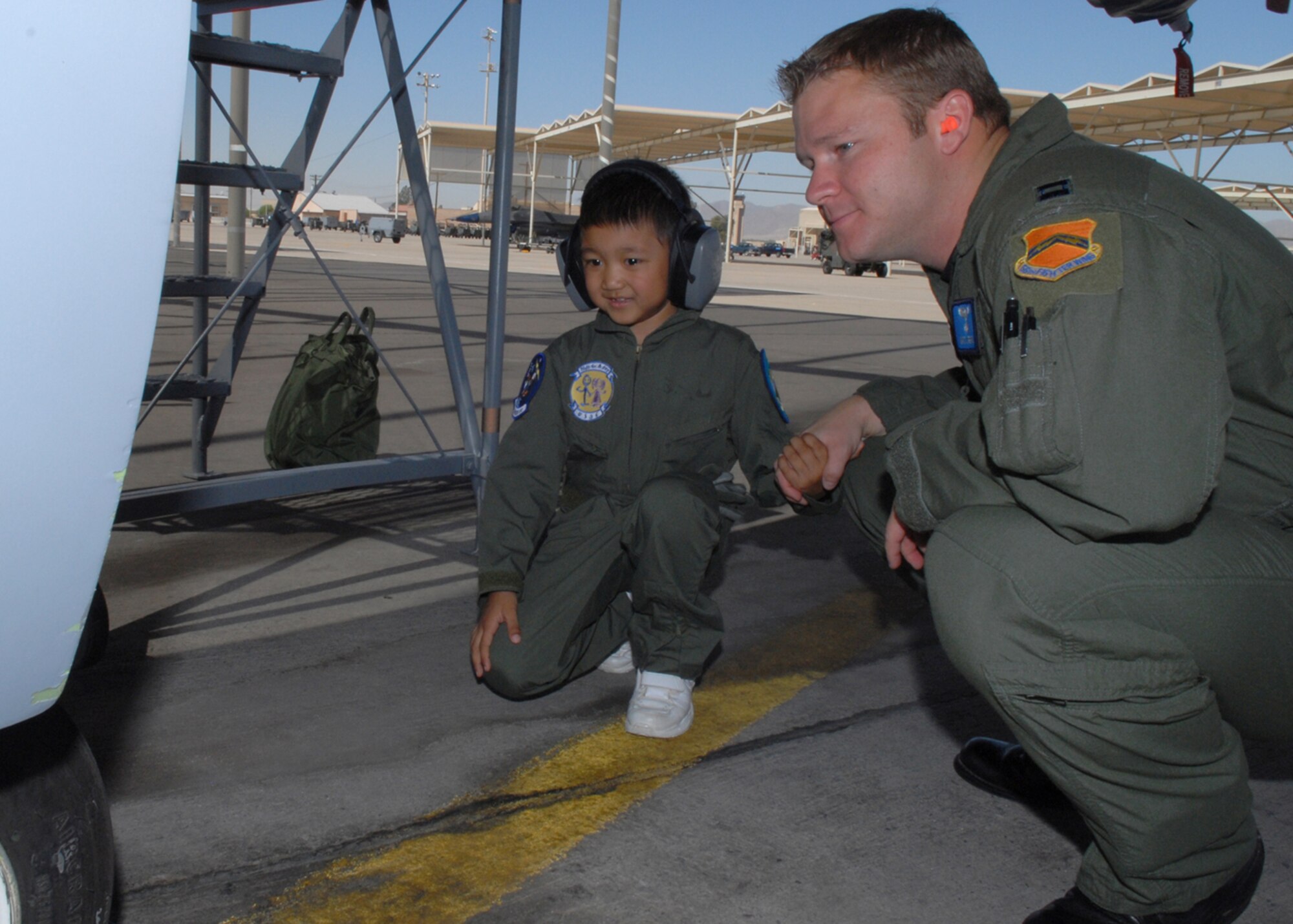 Captain Matthew Spears, a 309th Fighter Squadron instructor pilot, shows Jadon Cubarrubais, 5, an F-16 during the Pilot for a Day program, April 14, Luke Air Force Base, Ariz. (U.S. Air Force photo/Airman 1st Class Gustavo Gonzalez)