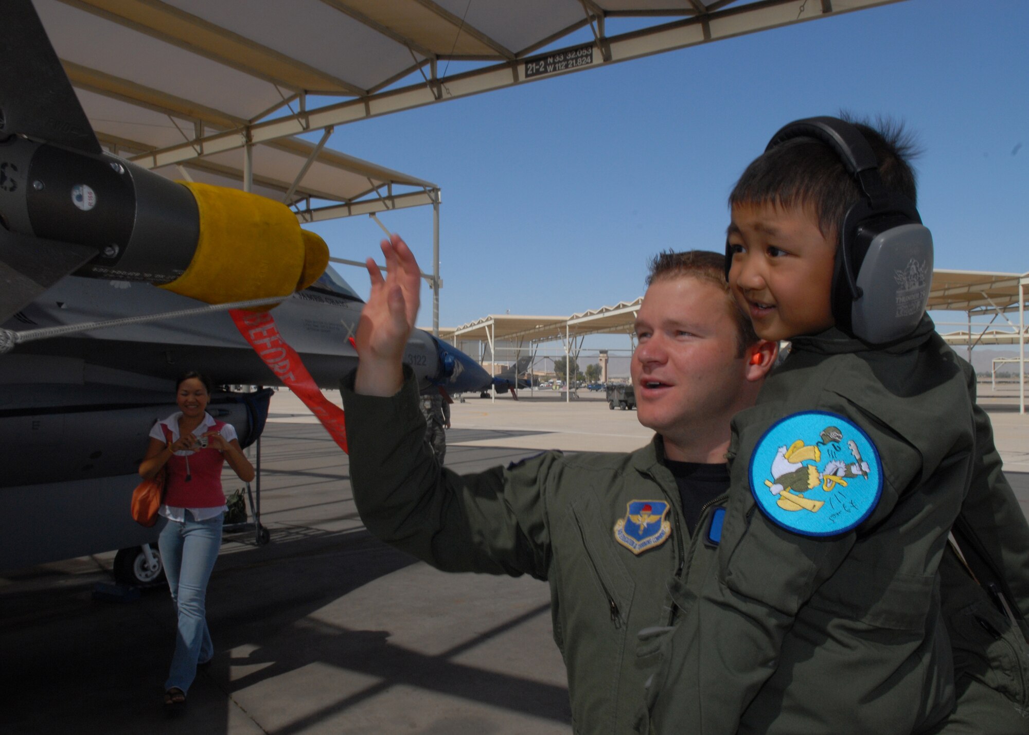 Captain Matthew Spears, a 309th Fighter Squadron instructor pilot, shows Jadon Cubarrubais, 5, an F-16 during the Pilot for a Day program, April 14, Luke Air Force Base, Ariz. (U.S. Air Force photo/Airman 1st Class Gustavo Gonzalez)