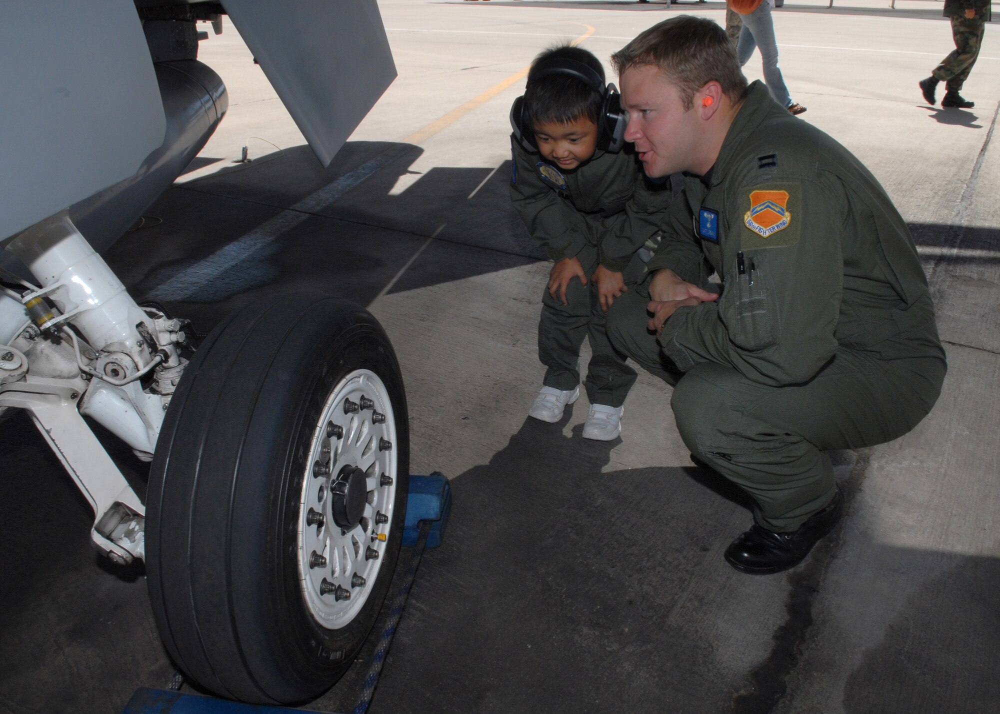 Captain Matthew Spears, a 309th Fighter Squadron instructor pilot, shows Jadon Cubarrubais, 5, an F-16 during the Pilot for a Day program, April 14, Luke Air Force Base, Ariz. (U.S. Air Force photo/Airman 1st Class Gustavo Gonzalez)