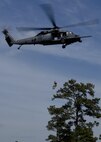 MOODY AIR FORCE BASE, Ga. -- A member of the 38th Rescue Squadron rappels from an HH-60G Pave Hawk dressed in a Vietnam-era style uniform during a re-dedication ceremony for Airman 1st Class William H. Pitsenbarger here April 18. Airman Pitsenbarger was a pararescueman who died in battle on April 11 1966, and was posthumously awarded the Air Force Cross and later the Congressional Medal of Honor. (U.S. Air Force photo by Airman 1st Class Brittany Barker)