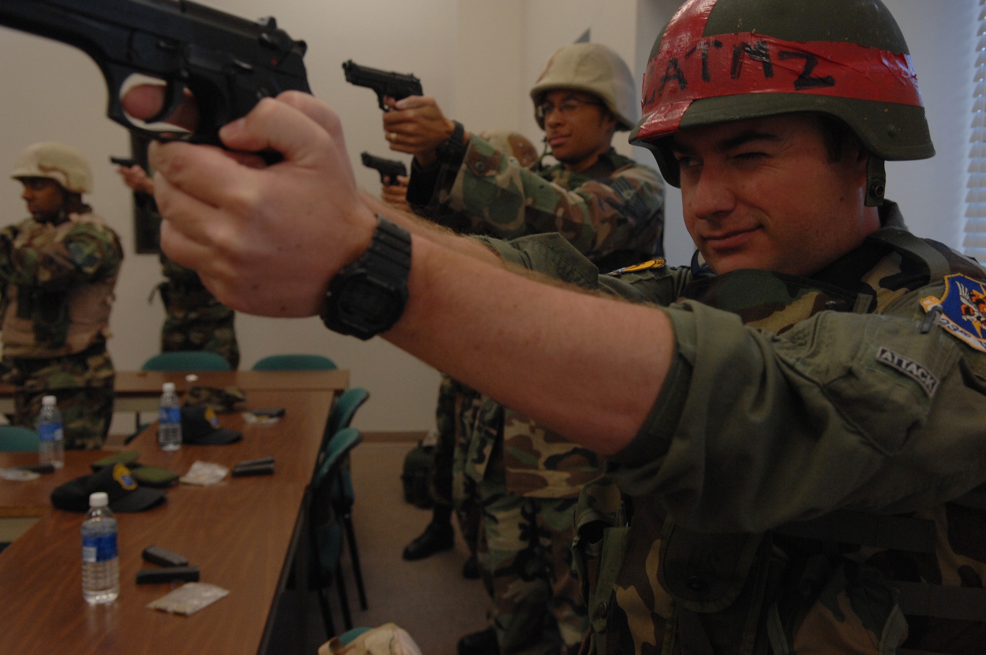 MOODY AIR FORCE BASE, Ga. -- Airmen practice sighting the M-9 Beretta handgun during combat arms training here April 16. After learning about the M-9 during a block of classroom instruction, students then finish the course by qualifying at the firing range. (U.S. Air Force photo by Senior Airman Gina Chiaverotti) 