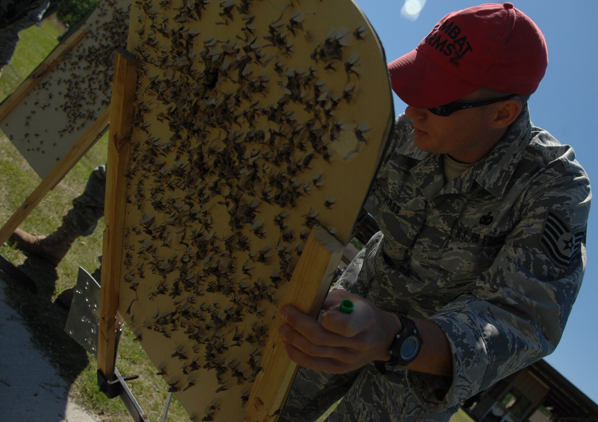 MOODY AIR FORCE BASE, Ga. -- Tech. Sgt. Stephen Glass, 23rd Security Forces Squadron combat arms instructor, scores a student's target during an M-9 Beretta handgun qualification course here April 16. Military personnel who are within 90 days of deploying must complete the course. (U.S. Air Force photo by Senior Airman Gina Chiaverotti)
