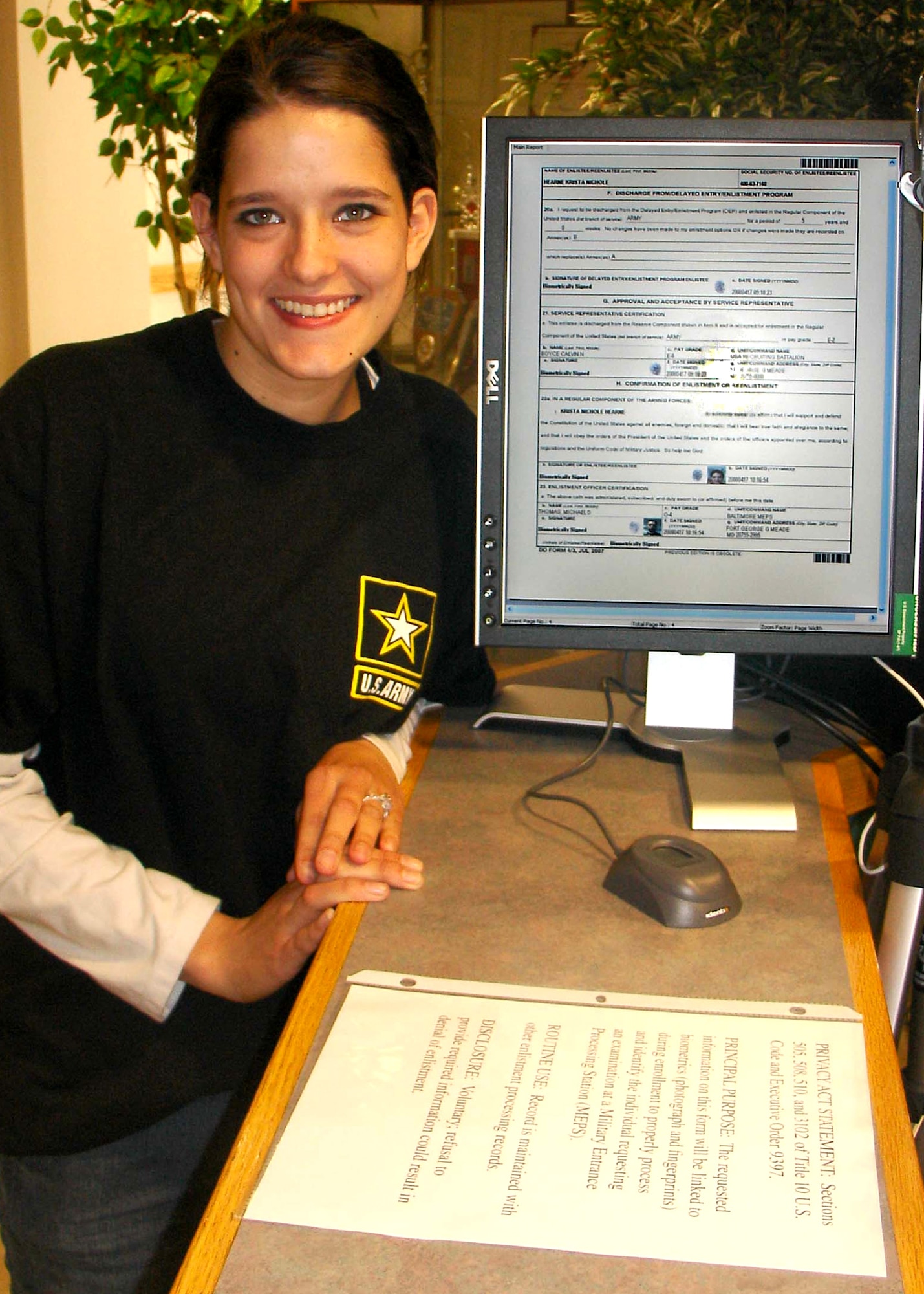 U.S. Army Recruit Krista Hearne, 19, of Salisbury, Md., poses with the electronic Army enlistment contract she signed with her fingerprint as she became the first person to enlist in the U.S. military using biometric signatures. (U.S. Army photo/Lt. Col. Robert S. Larsen)