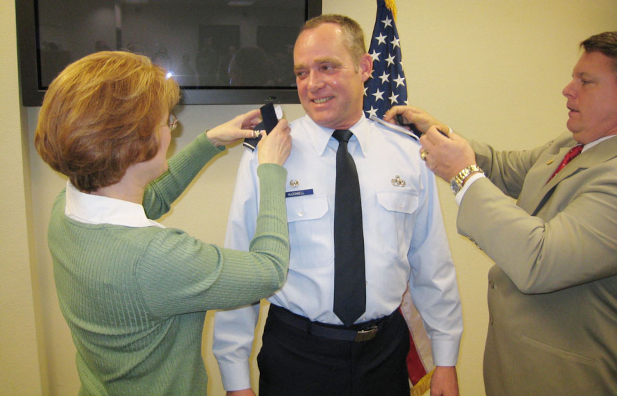 Col. James McDonnell, 507th Maintenance Group commander, recently pinned on his new rank with the help of his wife Wendy and Bill Frenier, former deputy commander for the 507th Maintenance Group.