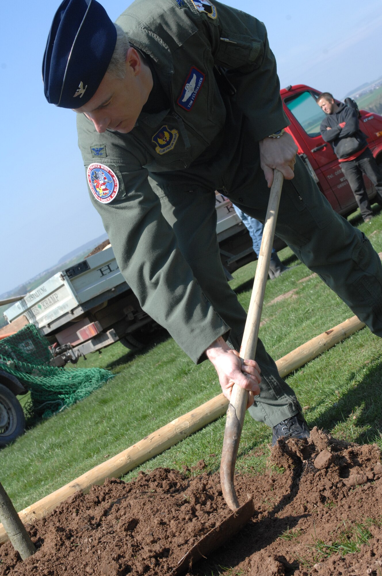 SPANGDAHLEM AIR BASE, Germany -- Col. Thomas Feldhausen, 52nd Fighter Wing commander, spreads dirt around the base of one of the many trees planted at the Eifel Mountain Golf Course April 18, 2008. Colonel Feldhausen and other members of the base planted the trees in honor of Earth Week.  (U.S. Air Force Photo/Airman 1st Class Jenifer Calhoun)