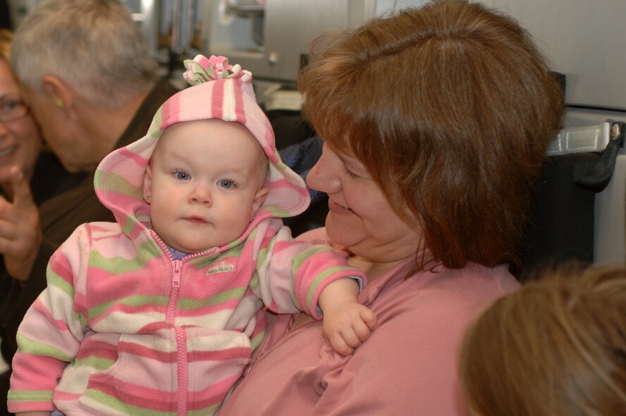 Cathy Walker, right, and her daughter Grace sit aboard a C-17 prior to take off from Ramstein April 21. Mrs. Walker and her three daughters are on their way to visit family while her husband is deployed. Photo by Airman 1st Class Nathan Lipscomb