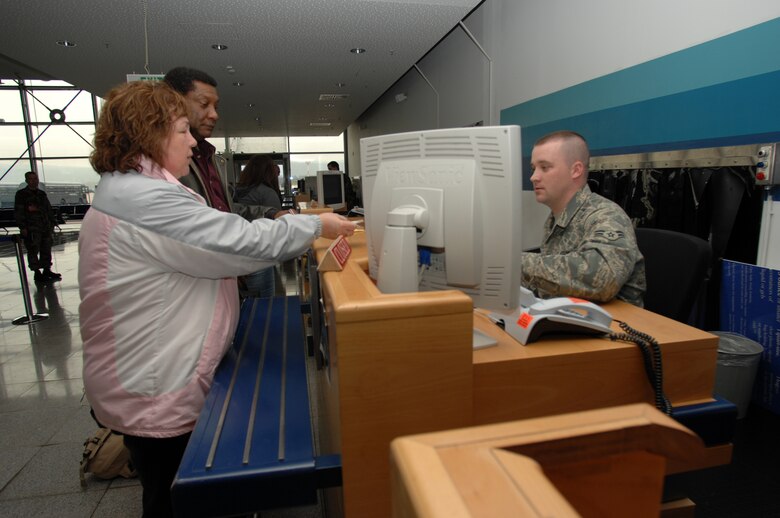 Retired Marine Corps Master Sgt. Charles Cue and his wife Karin (left) sign up for a Space-A flight April 21 at the Ramstein passenger terminal. Photo by Airman 1st Class Nathan Lipscomb