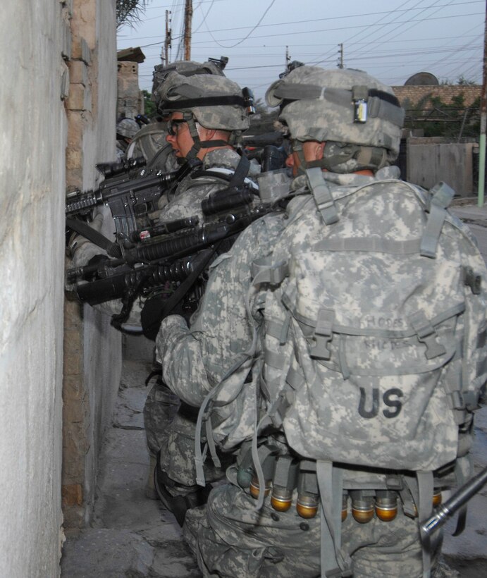 U.S. Army Soldiers enter a house in search of weapons caches  in Al Rashid, Baghdad, Iraq, on April 16, 2008. The soldiers are assigned to the 2nd Squadron, Company E, 2nd Stryker Cavalry Regiment.