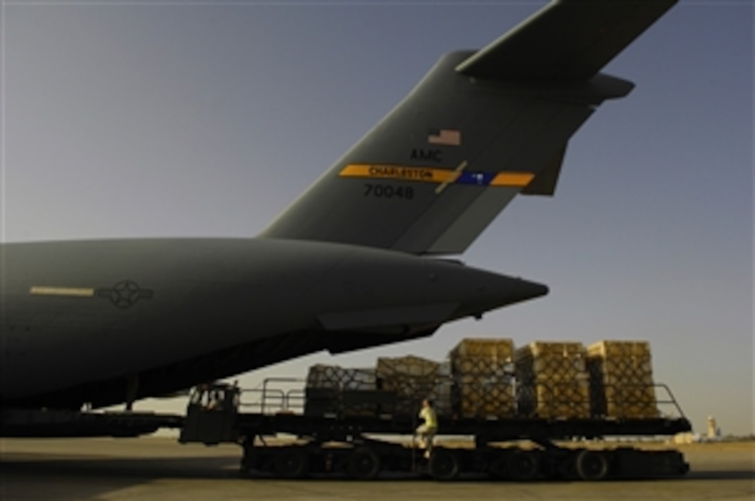 U.S. Air Force airmen unload pallets of supplies from a C-17 Globemaster III aircraft on the flight line at Sather Air Base, Iraq, on April 15, 2008.  