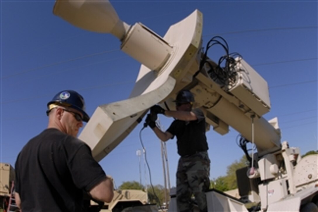 U.S. Air Force Master Sgts. Ed McManus, left, and Troy Wilkerson, both assigned to 169th Communications Flight, South Carolina Air National Guard, set up a commercial satellite antenna at the Beaufort Public Works Facility during an emergency exercise in Beaufort, S.C., April, 17, 2008. 