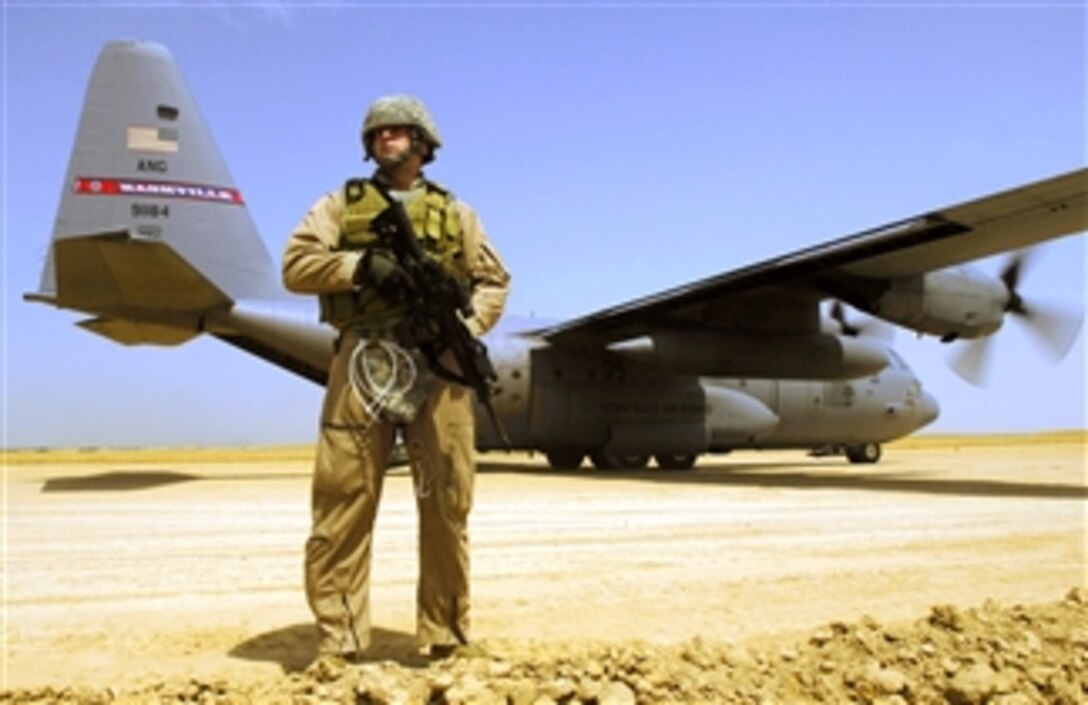 U.S. Air Force Senior Airman Matt Cooper provides security for a C-130 Hercules aircraft during a cargo mission in Afghanistan, April 18, 2008.  Cooper is part of a Fly Away Security Forces Team assigned to the 455th Expeditionary Security Forces deployed from Davis-Monthan Air Force Base, Ariz. 