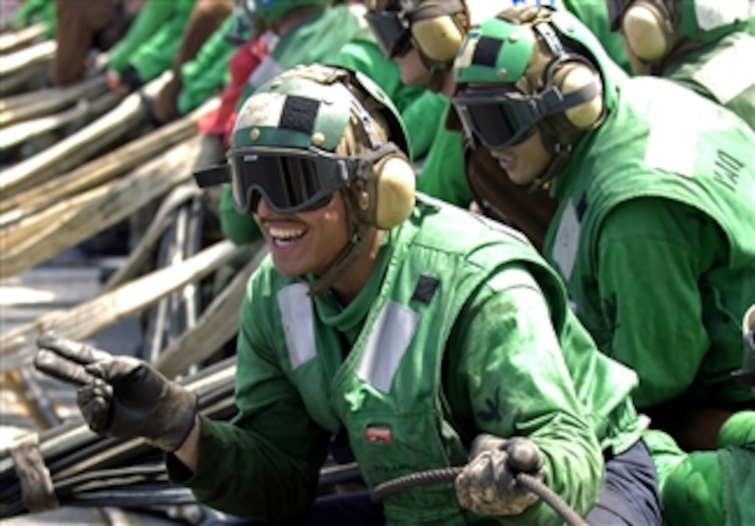 U.S. sailors aboard the aircraft carrier USS Kitty Hawk raise an aircraft barricade during flight deck drills in the Pacific Ocean, April 18, 2008. Aircraft barricades are used to help land damaged aircraft on the flight deck. The USS Kitty Hawk is conducting its last spring deployment training before being relieved by the nuclear-powered aircraft carrier USS George Washington later this summer.