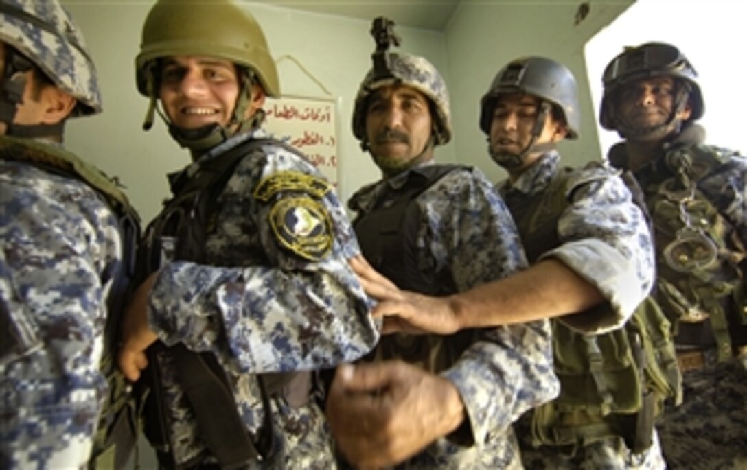 Iraqi police officers stand during a ceremony at the Iraqi National Police 3rd Battalion's headquarters before U.S. Army soldiers present them with U.S. Cavalry Combat Spurs, Jasr Diyala, Iraq, April 14, 2008. The U.S. soldiers are assigned to the 3rd Infantry Division's 3rd Squadron, 1st Cavalry Regiment, 3rd Brigade Combat Team.