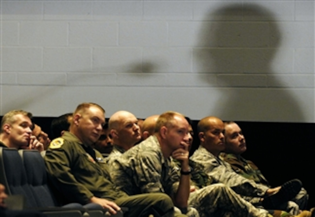 With the shadow of the defense secretary on the wall above them, students of the Air War College and the Air Command and Staff College listen to remarks by Defense Secretary Robert M. Gates at Maxwell Air Force Base, Ala., April 21, 2008.  