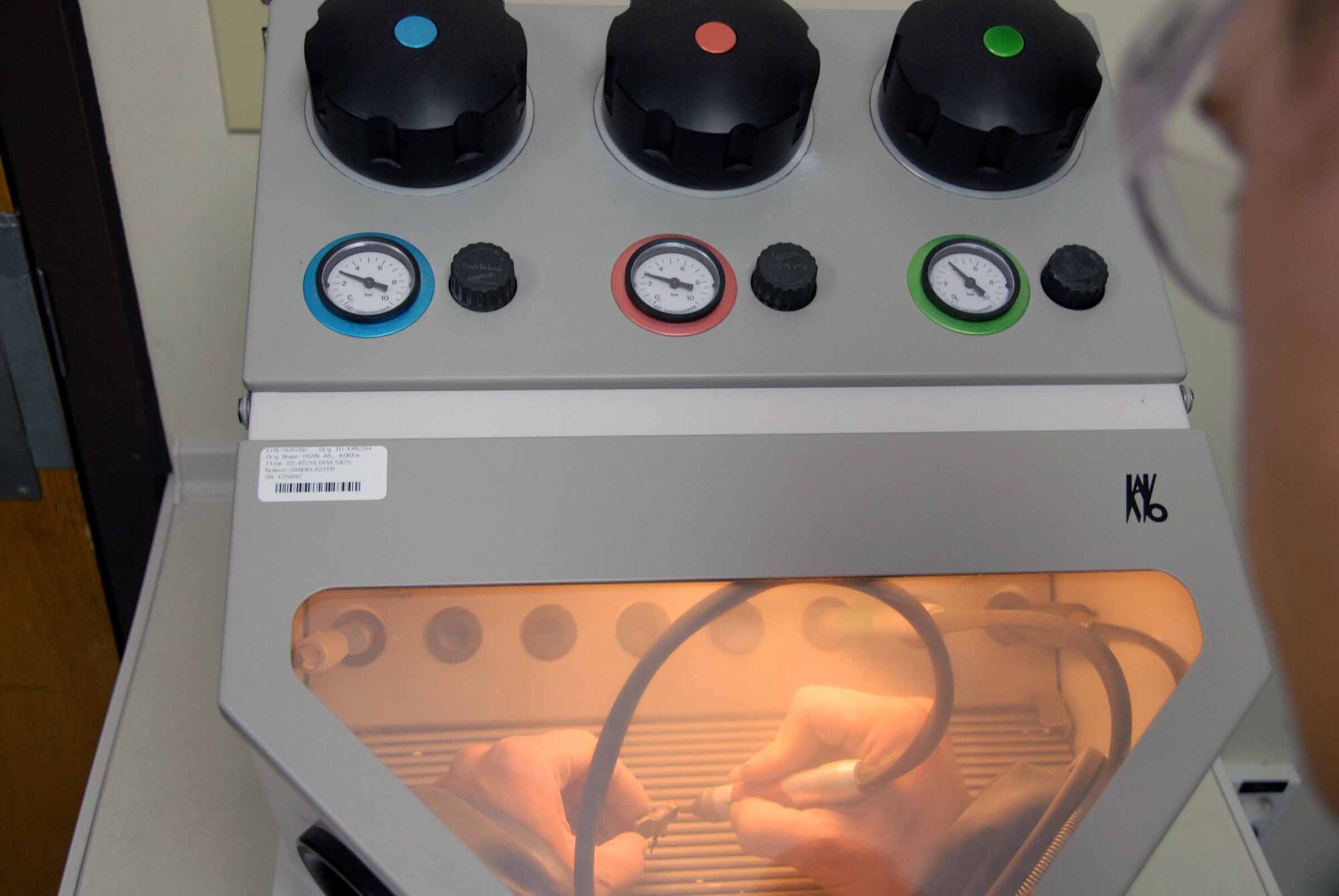 OSAN AIR BASE, Republic of Korea -- Senior Airman Dennis Bermel, 51st Dental Squadron lab technician, sandblast all of the stone and oxides off a molding April 22. This is the second step of a two-day process that will result in a gold cast. (U.S. Air Force photo/Staff Sgt. Lakisha Croley)