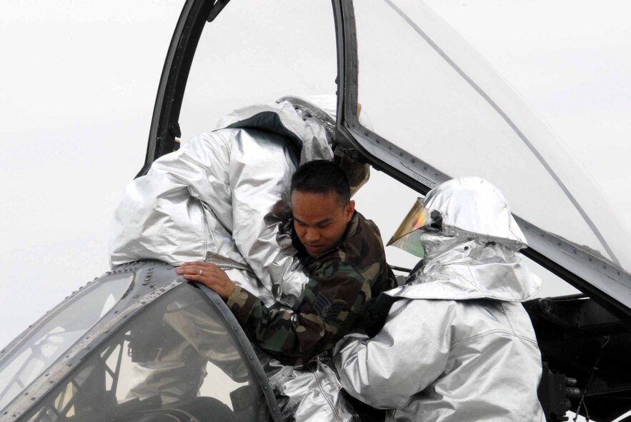 OSAN AIR BASE, Republic of Korea –Team Osan fire fighters performs an egress exercise on 25th Aircraft Maintenance Unit member during the 51st Fighter Wing’s Unit Compliance Inspection April 21. The UCI is conducted to ensure each Air Force base is in compliance with Air Force standards and directives. (U.S. Air Force photo/Staff Sgt. Lakisha Croley)