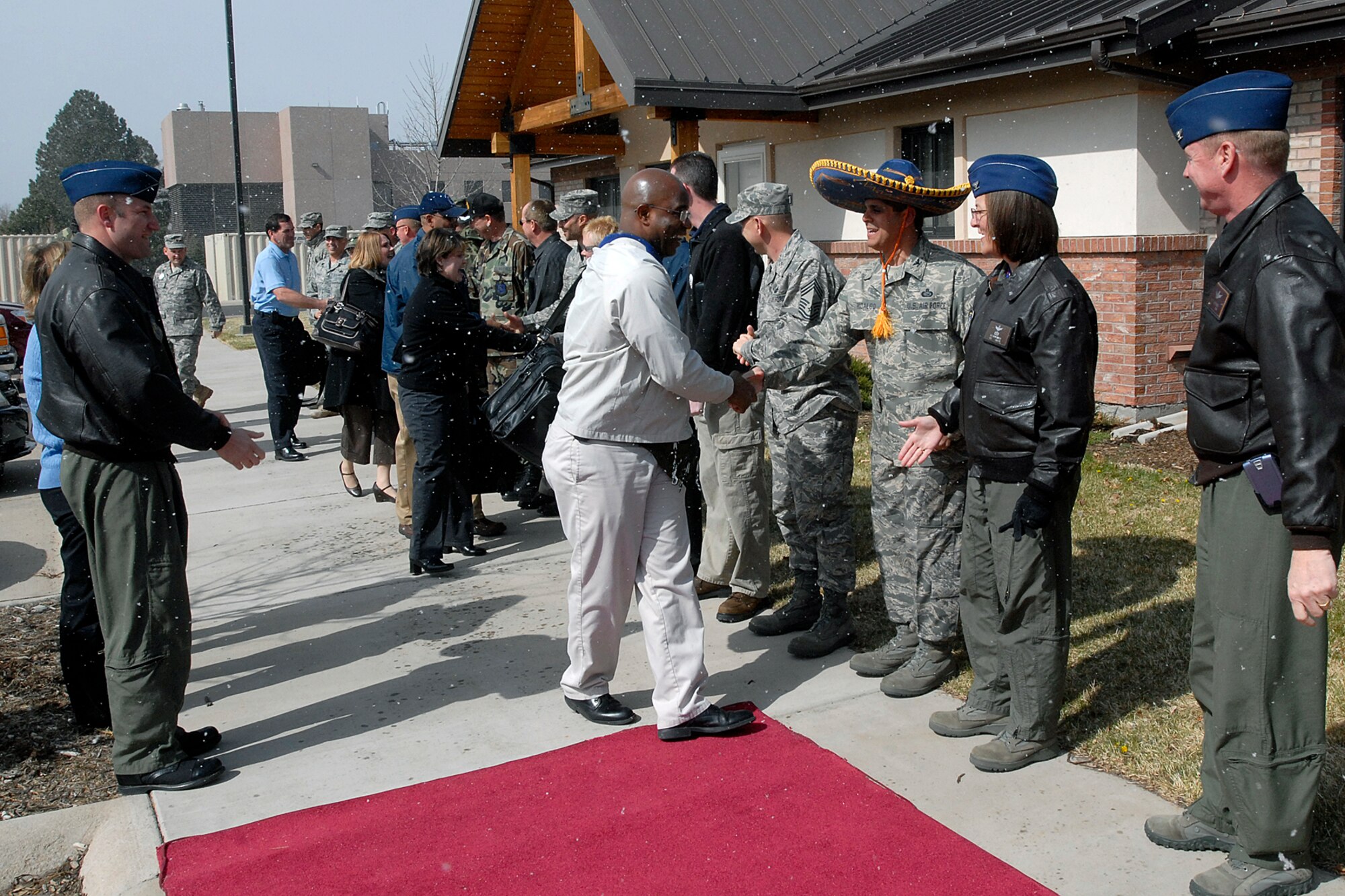 Col. Manny Hidalgo, 21st Mission Support Group commander, shakes hands with members of the Air Force-level LeMay inspection team while 21st Space Wing members give a send off April 11 in temporary housing on Peterson. The team inspected the 21st Services Squadron April 7-11 to see if they qualified as the “best of the best” of services squadrons throughout the Air Force. (U.S. Air Force photo/Larry Hulst)