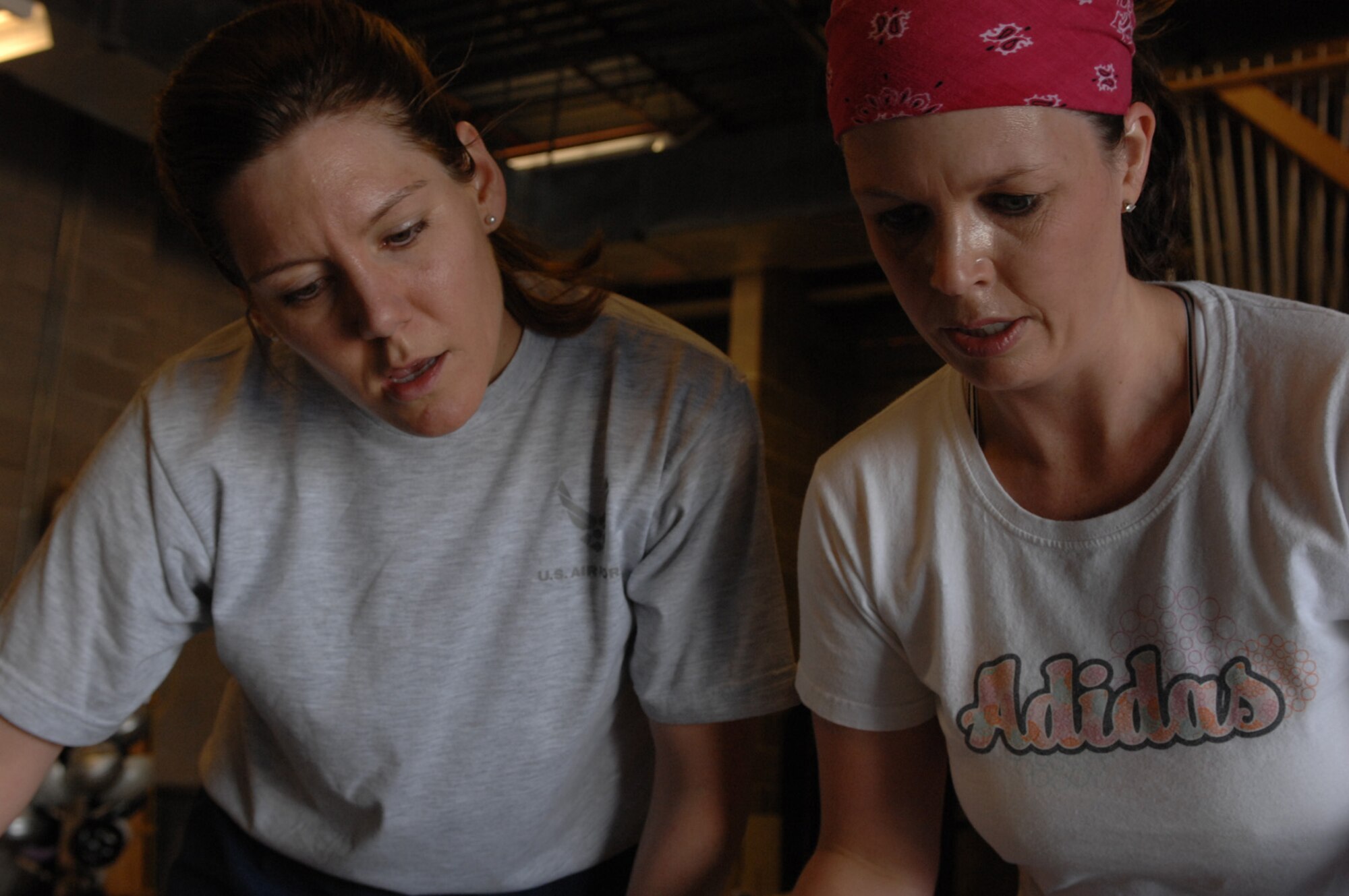 (Left) Capt. Amy Nash, 34th Bomb Squadron weapons systems officer, and teammate Jody Cameron participate in a mental obstacle during the 2008 Ellsworth Amazing Race April 17. The annual race challenges two-person teams against each other through nine mental and physical challenges within a two-hour time limit; 17 teams competed this year. (U.S. Air Force photo/ Airman 1st Class Adam Grant)