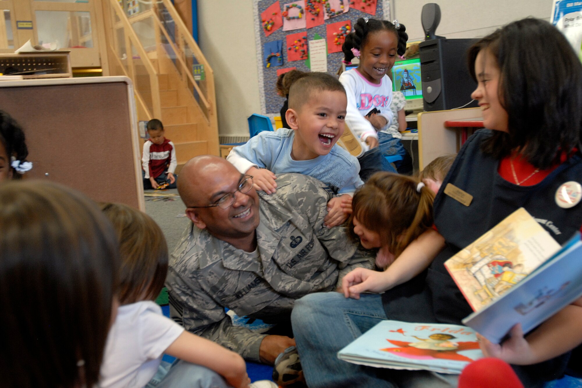 Chief Master Sgt. Laten Williams joins in the fun with children at the Peterson Child Development Center annex for reading time April 9 on Peterson Air Force Base, Colo. The team inspected the 21st Services Squadron April 7-11 to see if they qualified as the “best of the best” of services squadrons throughout the Air Force. (U.S. Air Force photo/Larry Hulst)