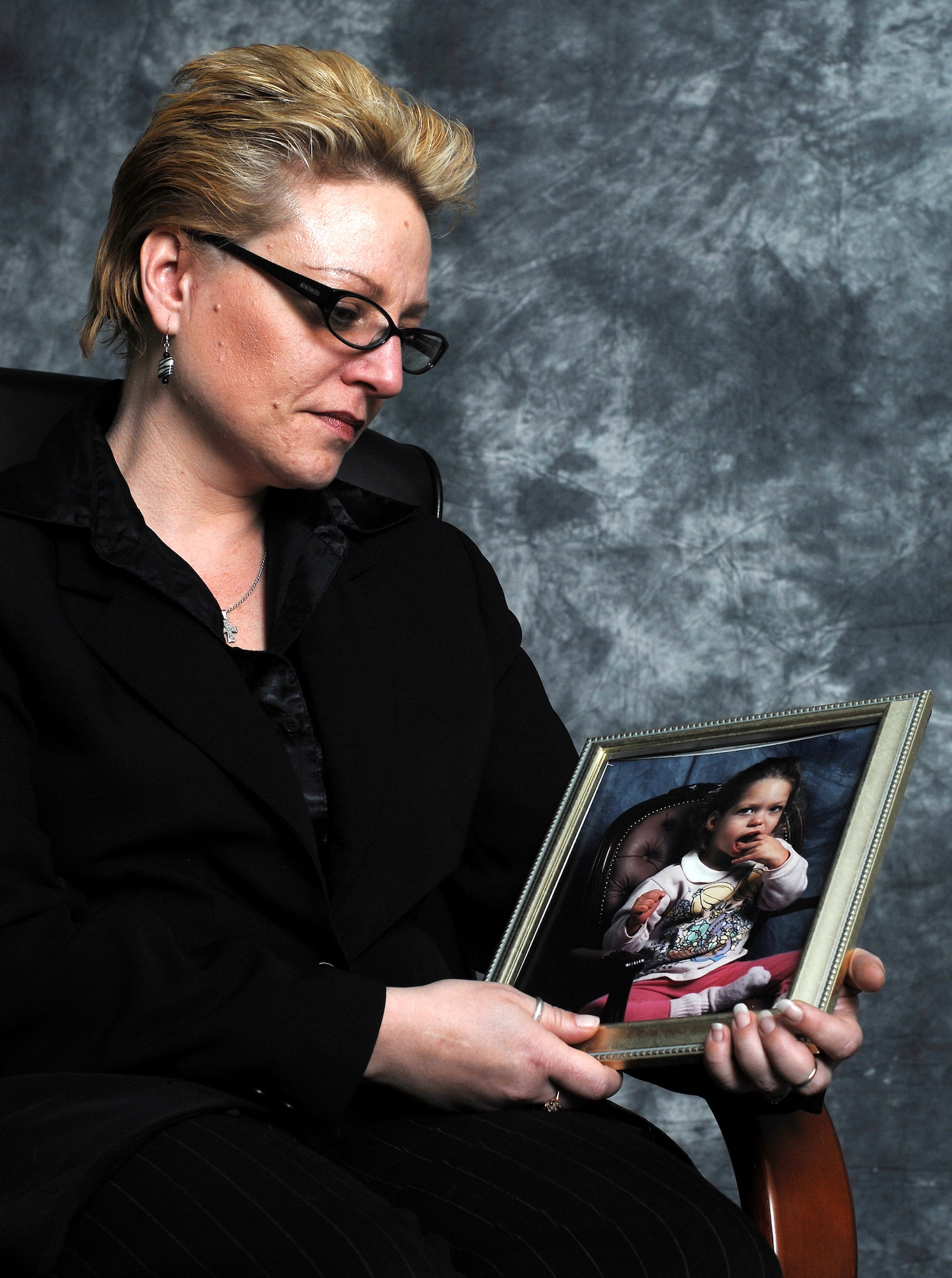 MINOT AIR FORCE BASE, N.D. -- Ruth Zorbaugh looks affectionately at a photo of her daughter, Miranda, here April 21. Miranda passed away in 1999. The Air Force Assistance fund helped the Zorbaugh family during a time of family tragedy. (U.S. Air Force photo by Airman 1st Class Kelly Timney)