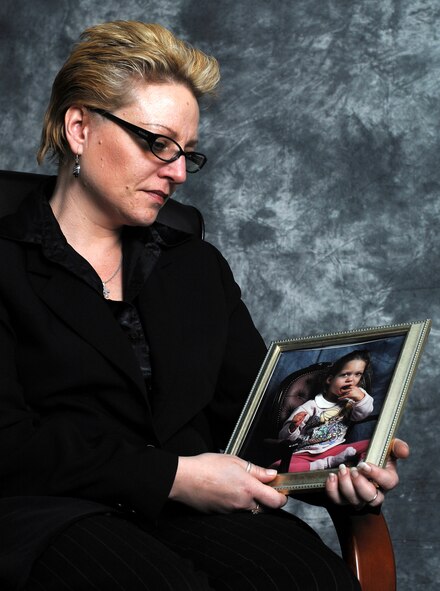 MINOT AIR FORCE BASE, N.D. -- Ruth Zorbaugh looks affectionately at a photo of her daughter, Miranda, here April 21. Miranda passed away in 1999. The Air Force Assistance fund helped the Zorbaugh family during a time of family tragedy. (U.S. Air Force photo by Airman 1st Class Kelly Timney)