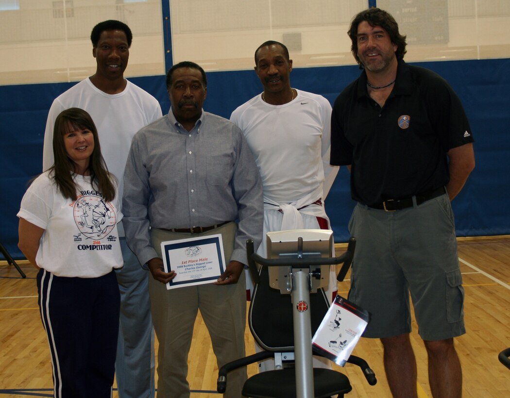 Charlie George, DPB, (third from left), was the winner of Buckley's Biggest Loser competition, after dropping more than 9.2 percent of his body fat. Mr. George received a stationary exercise bike and met several former NBA players at the competition's closing ceremony. Pictured (from left) are: Virginia Harris, Buckley fitness center; Ervin Johnson of the Milwaukee Bucks; Mr. George; former Denver Nuggets players Walter Davis and Mark Randall. (Courtesy photo)