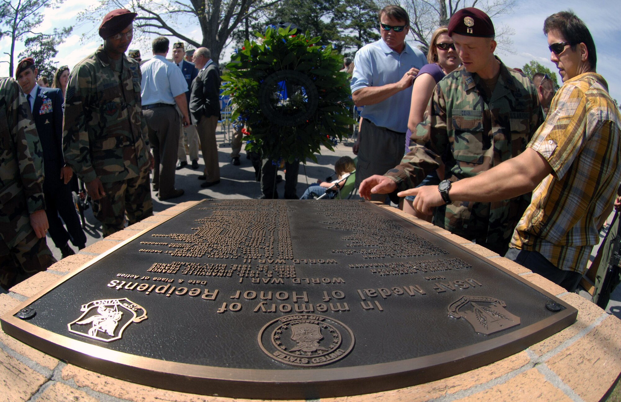Friends, family and members of the 23rd Wing gather around a monument dedicated to the Airmen who received the Medal of Honor at Moody Air Force Base, Ga., April 18. The ceremony was to add the name of Airman 1st Class William Pitsenbarger, an Air Force pararescueman who lost his life while treating wounded soldiers during the Vietnam War. (U.S. Air Force photo/Senior Airman Angelita Lawrence) 