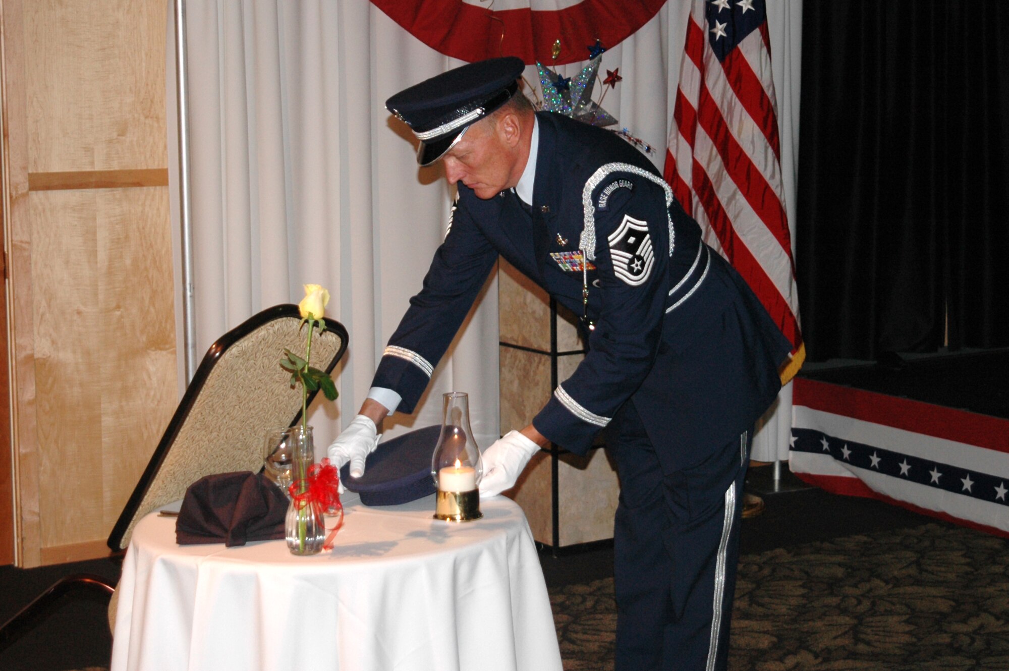 Senior Master Sgt. Joe Shern places a hat on the POW/MIA table at the 169th Intelligence Squadron's dining out in 2005.  The table symbolizes the unit's commitment to never forget those who were taken prisoner, or who have never returned from armed conflict.  Sgt. Shern is a member of the Utah Air National Guard's Base Honor Guard.
U.S. Air Force photo by:  Master Sgt. Burke Baker