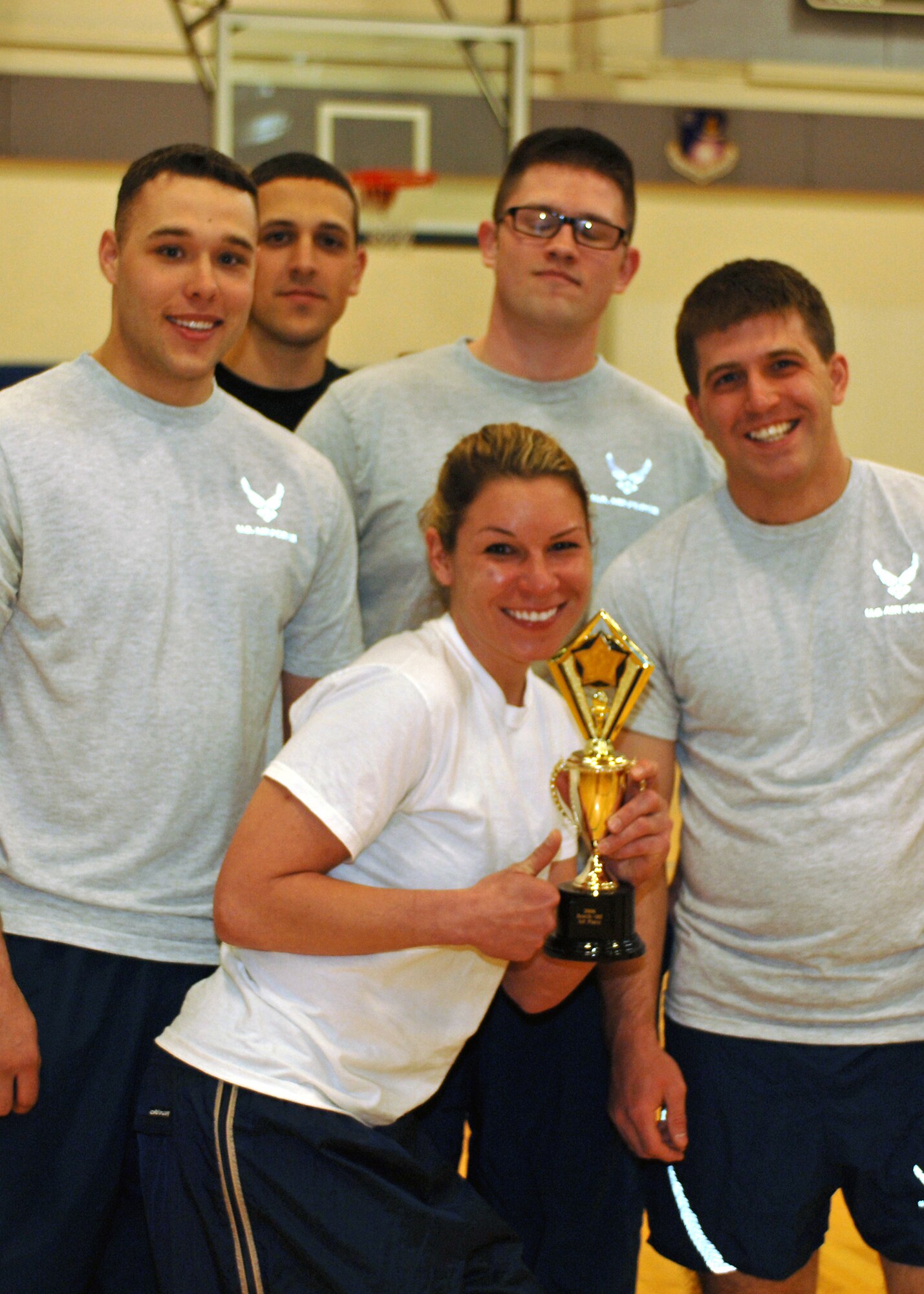 FAIRCHILD AIR FORCE BASE, Wash. – From left, Airman 1st Class Brad Gaff, Airman 1st Class Larry Noonan, 2nd Lt. John Jarzabek, Airman 1st Class Steven Bonner and Tech. Sgt. Mickie Newman, all members of the 92nd Communication Squadron, won first place with the most repetitions in a Bench Off at the base fitness center April 21. The men had to bench 75 percent of their own body weight while the women benched 45 percent. (U.S. Air Force photo / Airman 1st Class Melissa Barnett)