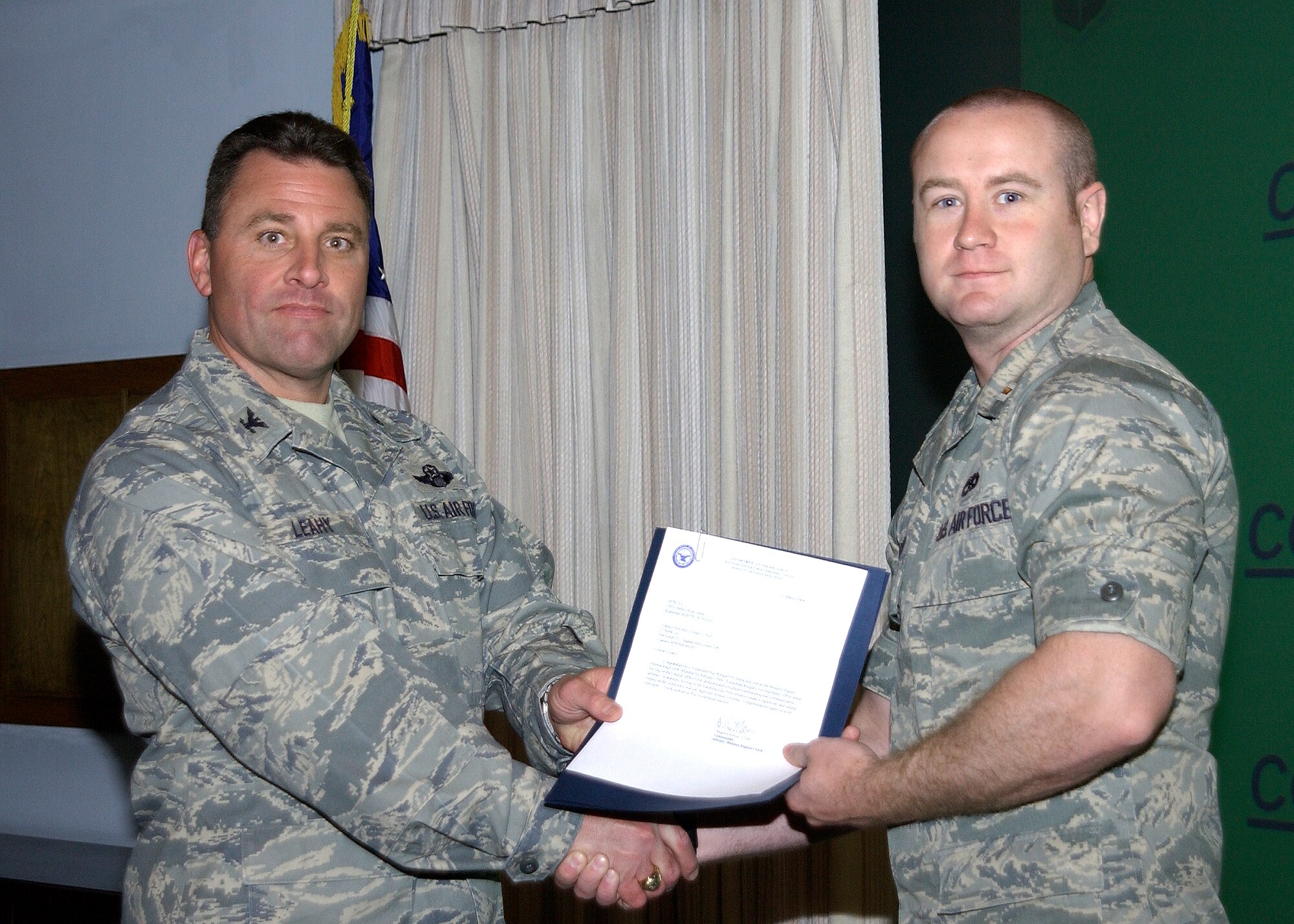 CANNON AIR FORCE BASE N.M.-- Col.Timothy Leahy, 27th Special Operation Wing commander, presents 2nd Lt. Ray Kingery, 27th Special Operations Equipment Maintenance Squadron, with the award for CGOC outstanding member for the month of February.  The award was presented during the weekly staff meeting April 22.  (U.S. Air Force photo/Airman Maynelinne De la Cruz)  