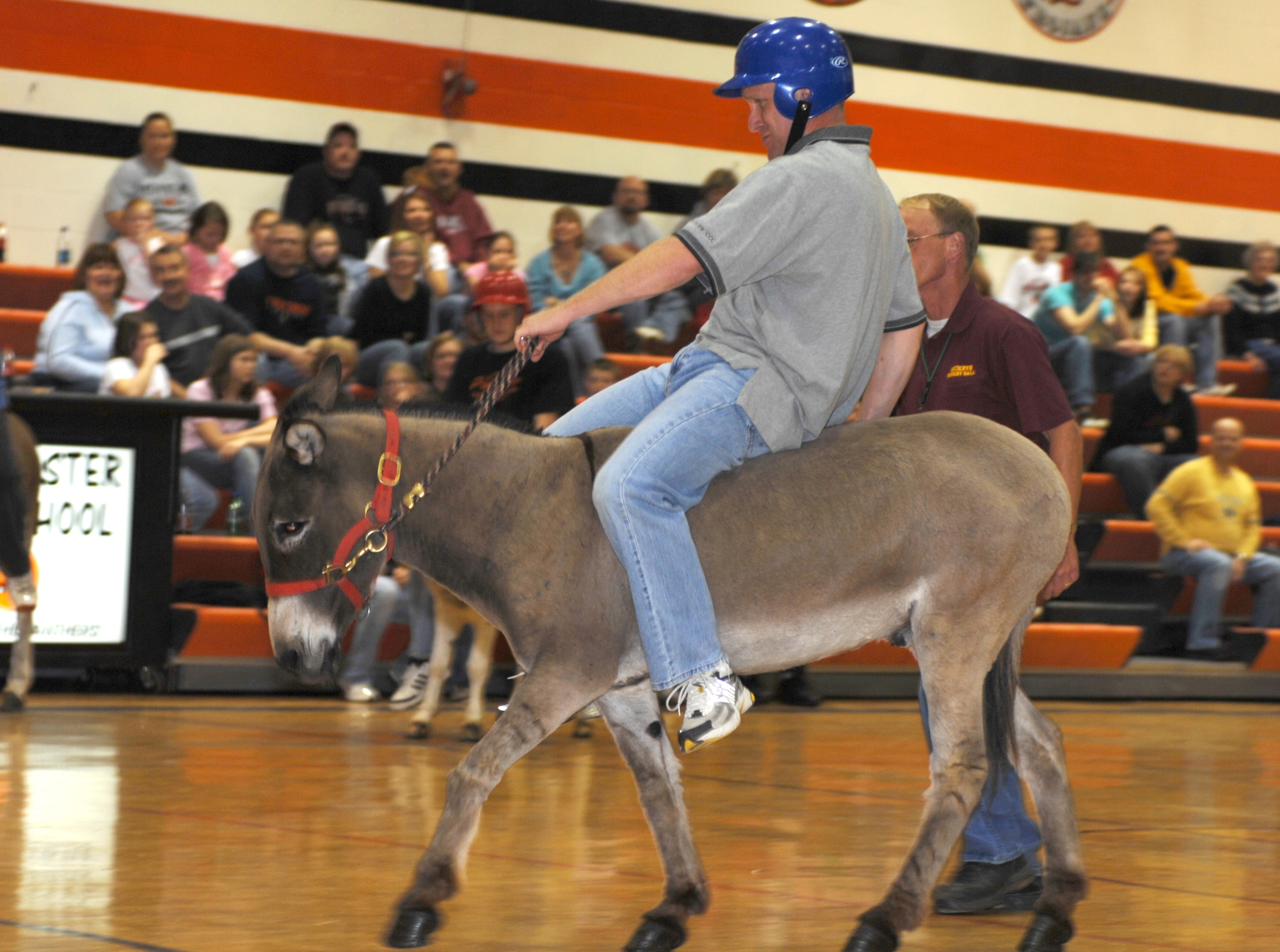 KNOB NOSTER, Mo. - Chief Master Sgt. Brian Hornback, 509th Bomb Wing command chief, demonstrates proper donkey riding form April 19 during a Donkey Basketball fundraiser for the Knob Noster high School Athletic Booster Club at Knob Noster High School. Chief Hornback represented Whiteman AFB for a local community team during. The community team dropped their first game against the Knob Noster high School faculty 8-6 and their second game against the Knob Noster juniors 8-4 to finish fourth for the tournament. (U.S. Air Force photo/1st Lt. Matthew Miller)
