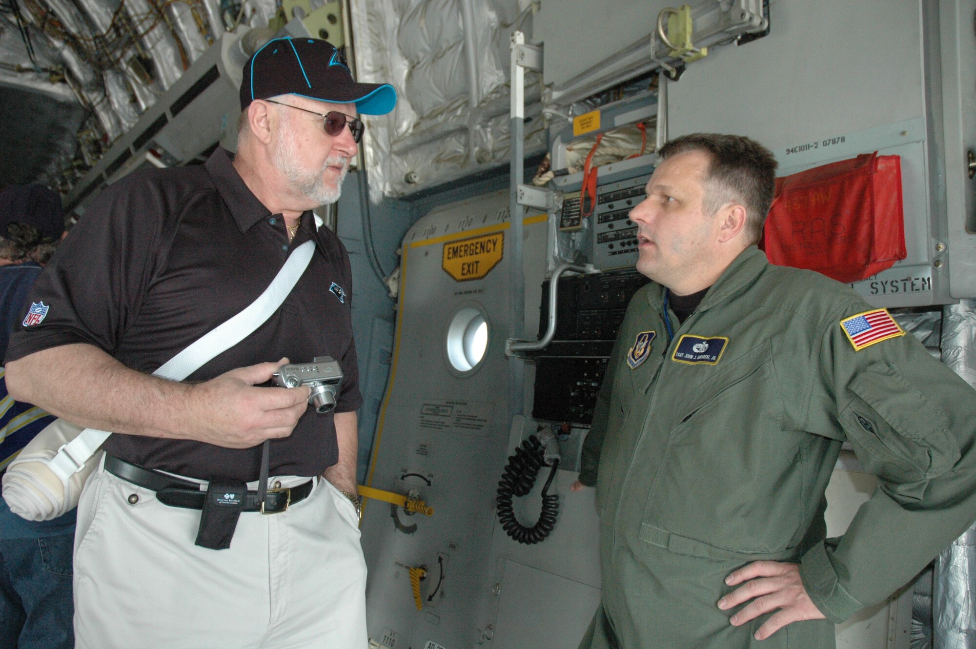 Technical Sergeant John Urbanski Jr., 315th Aircraft Maintenance Squadron, Charleston Air Force Base, S.C., talks with a spectator at the Wilmington, N.C. 2008 Coastal Carolina Air Show. (photo by Senior Airman Dani Pacheco, USAFR)