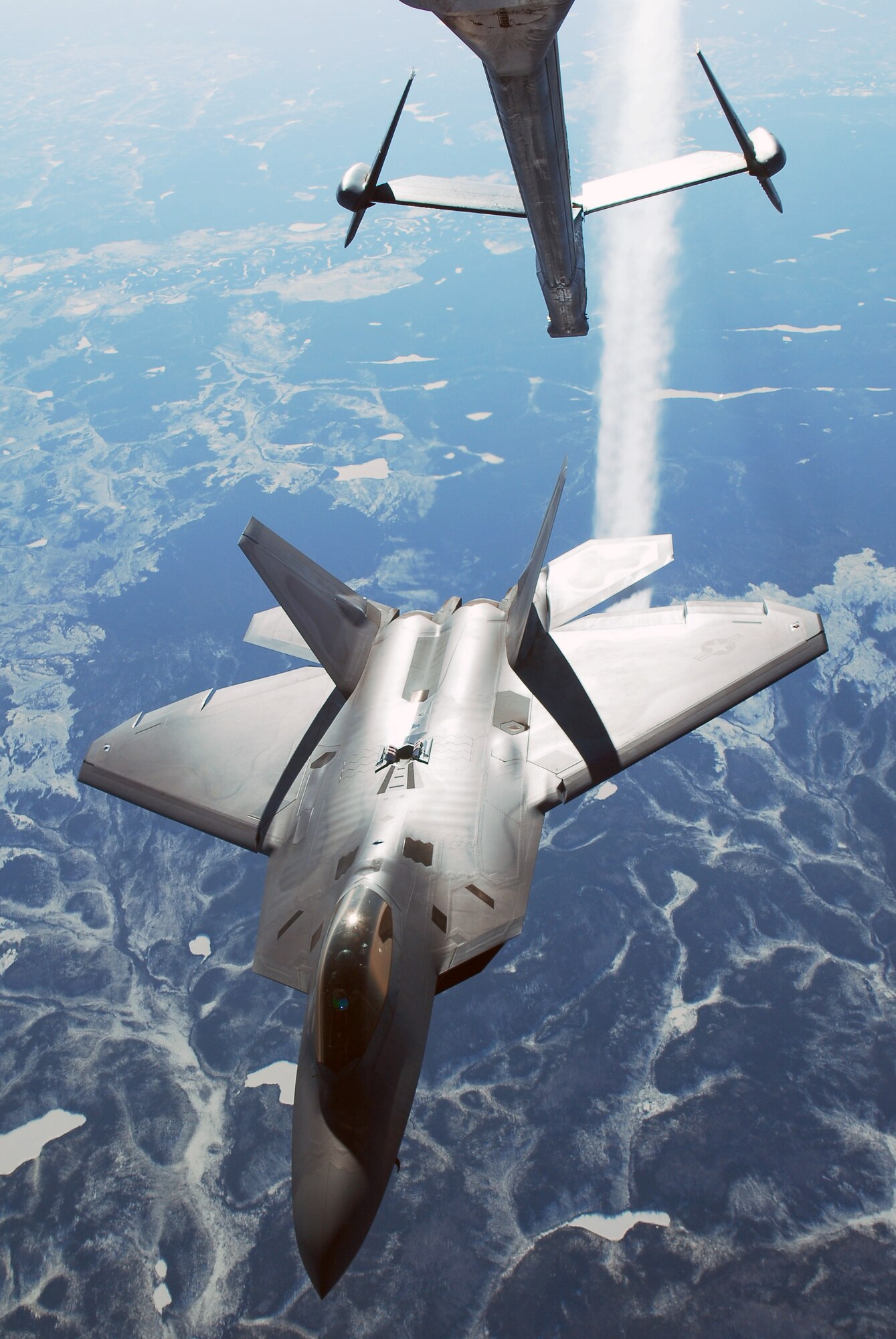 A F-22 Raptor breaks away after being refueled behind a KC-10 Extender while at 26,000 feet April 17, 2008, at Eielson Air Force Base, Alaska. RED FLAG-Alaska 08-2 is a series of Pacific Air Forces field training exercises for U.S Forces and allies that provide joint offensive counter-air, indirection, close air support, and large force employment training in a simulated combat environment. The F-22 Raptor is assigned to Elmendorf Air Force Base, Alaska. (U.S. Air Force Photo/Airman 1st Class Jonathan Snyder)