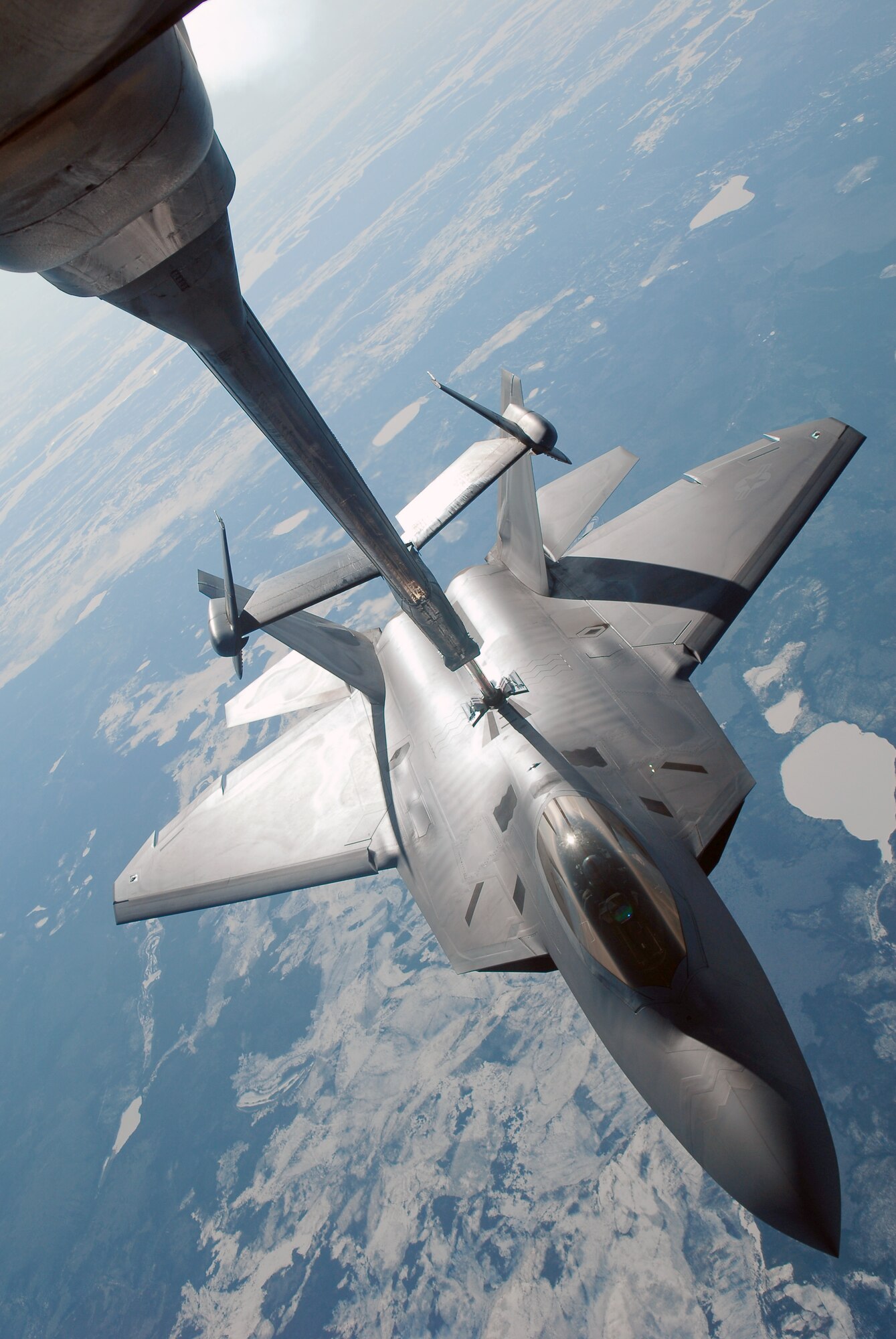 A F-22 Raptor refuels behind a KC-10 Extender while at 26,000 feet April 17, 2008, at Eielson Air Force Base, Alaska. RED FLAG-Alaska 08-2 is a series of Pacific Air Forces field training exercises for U.S Forces and allies that provide joint offensive counter-air, indirection, close air support, and large force employment training in a simulated combat environment. The F-22 Raptor is assigned to Elmendorf Air Force Base, Alaska. (U.S. Air Force Photo/Airman 1st Class Jonathan Snyder)
