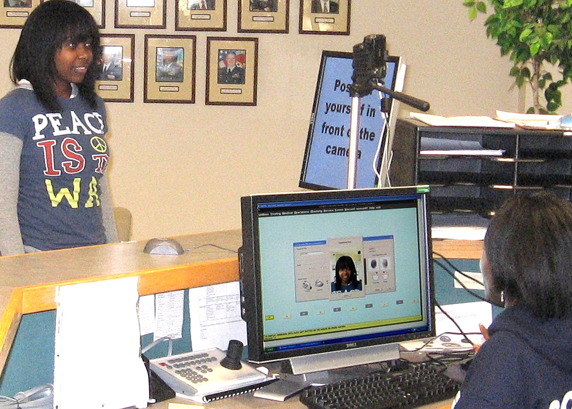 LaTasha Johnson, Baltimore Military Entrance Processing Station information technology specialist, completes the first Defense Department biometric enrollment April 16 with Air Force Recruit Janelle Jameson. The 22-year-old Baltimore native is the first person to go through the E-security enrollment process. (Courtesy photo/Staff Sgt. Karen Thomas)