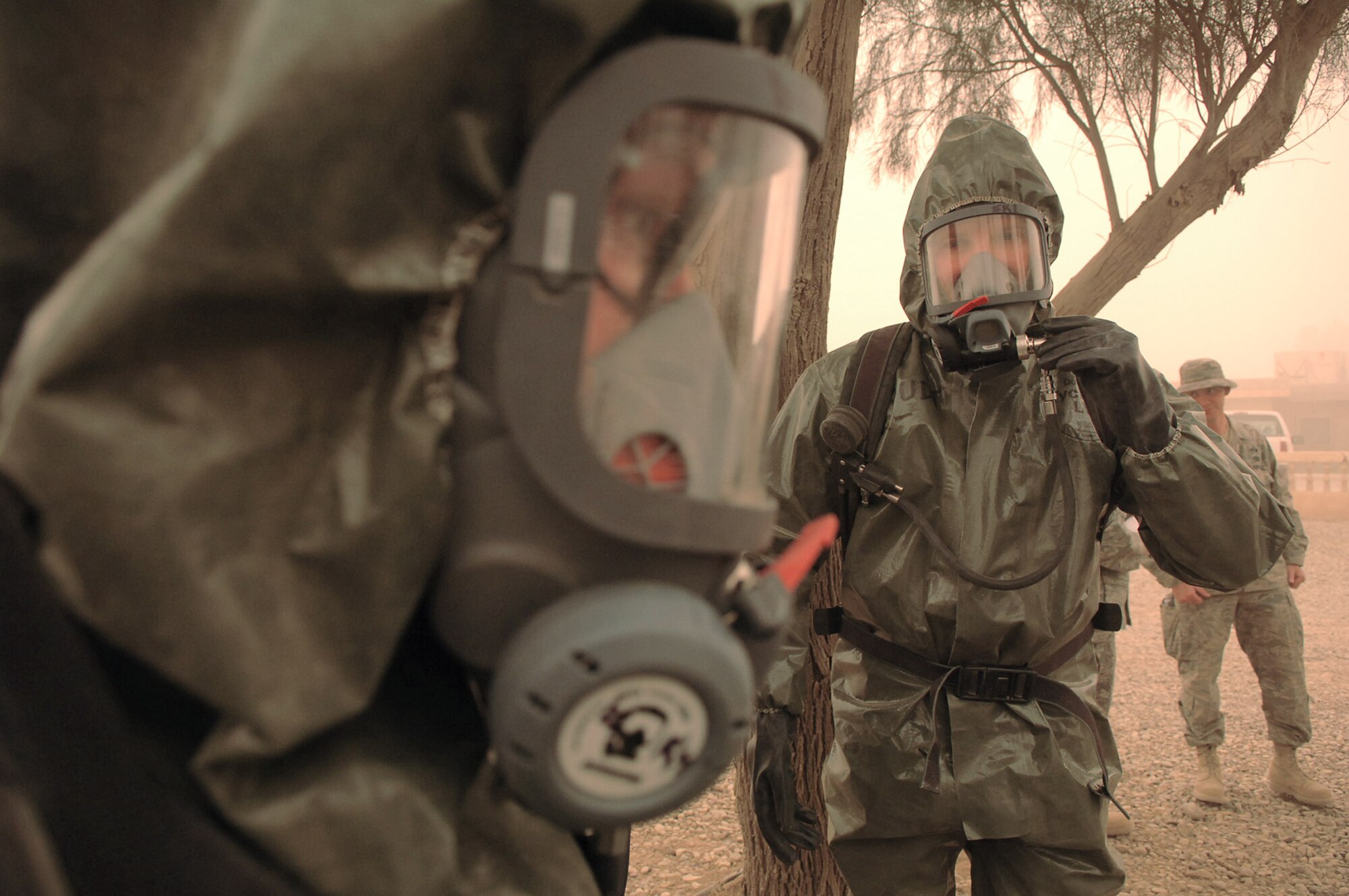 Staff Sgt. Amber Albano and Senior Master Sgt. Thomas Stoudt prepare to enter a building containing an unknown powder substance during a training scenario at Balad Air Base, Iraq, April 17. The scenario was one of many that Airmen from Balad, Kirkuk, Ali Base and Al Asad Airfield participated in during a week-long emergency management training session which concluded April 19. Sergeant Albano is deployed to 506th Expeditionary Civil Engineer Squadron as the emergency manager at Kirkuk Regional AB. Sergeant Stoudt is deployed to Southwest Asia as the functional manager for the emergency management career field. (U.S. Air Force photo/Senior Airman Julianne Showalter)