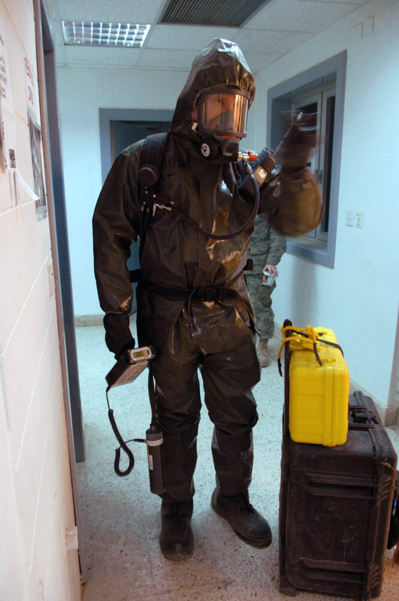 Senior Master Sgt. Thomas Stoudt shakes a light stick as he proceeds down a hallway while seeking out an unknown powder substance during a training event at Balad Air Base, Iraq, April 17. The training session was one of many that Airmen from Balad, Kirkuk Regional Air Base, Ali Base and Al Asad Airfield participated in during a week-long emergency management training session that concluded April 19. Sergeant Stoudt is deployed to Southwest Asia as the functional manager for the emergency management career field. (U.S. Air Force photo/Senior Airman Julianne Showalter)